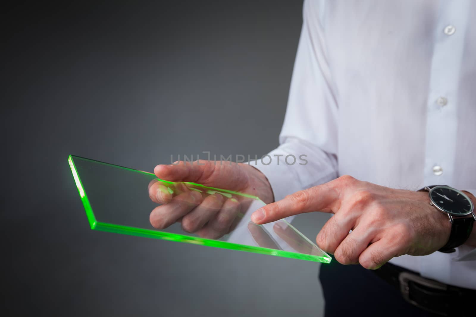 Male hands holding blank futuristic transparent digital tablet pc computer with copy space