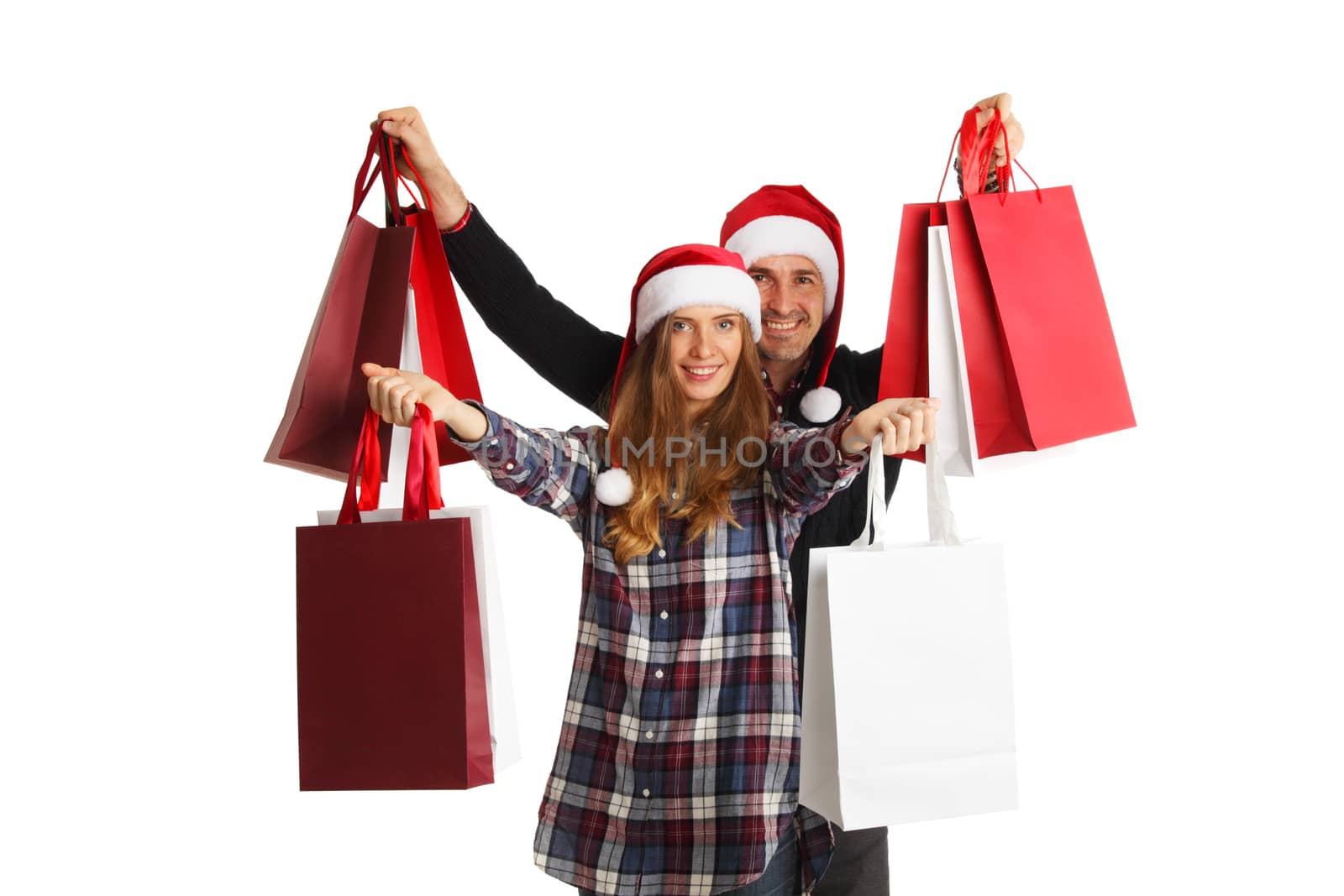 Happy beautiful couple holding many bags with christmas gifts isolated on white background