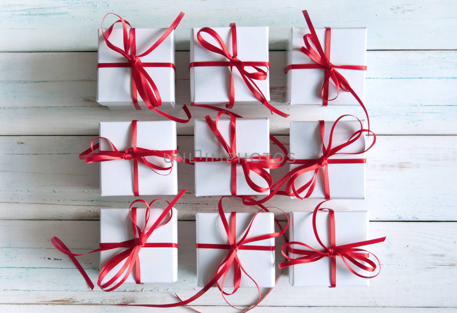 White gift boxes with red ribbon 