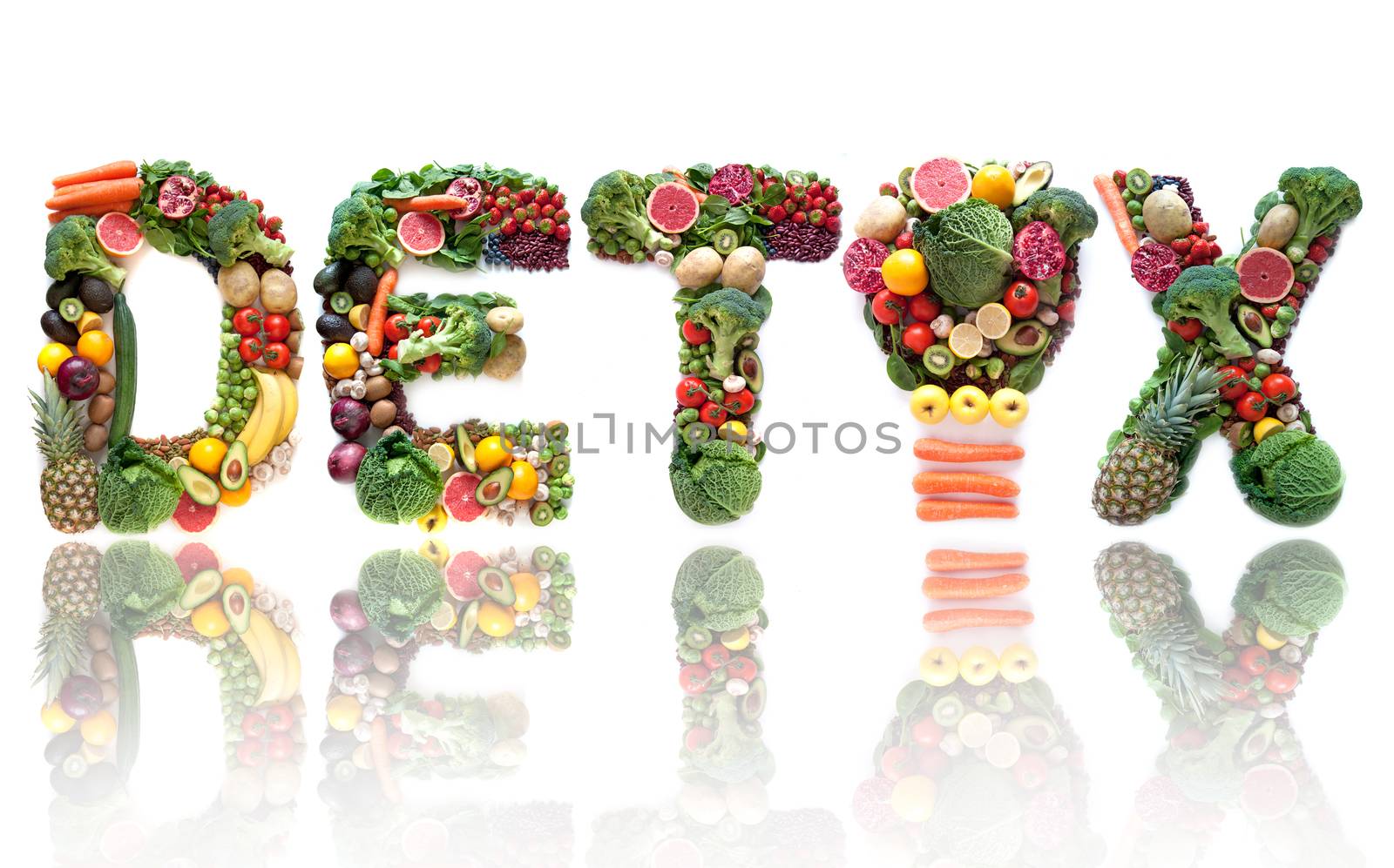 Detox spelt using large letters made of fruits and vegetables including light bulb symbol