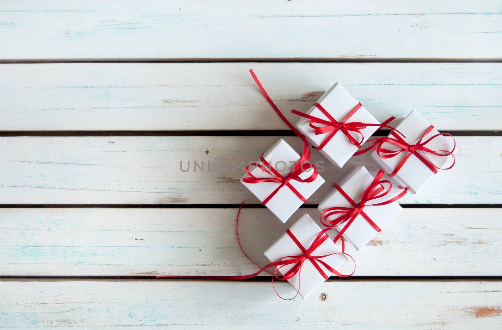 White gift boxes tied with red ribbon with background space