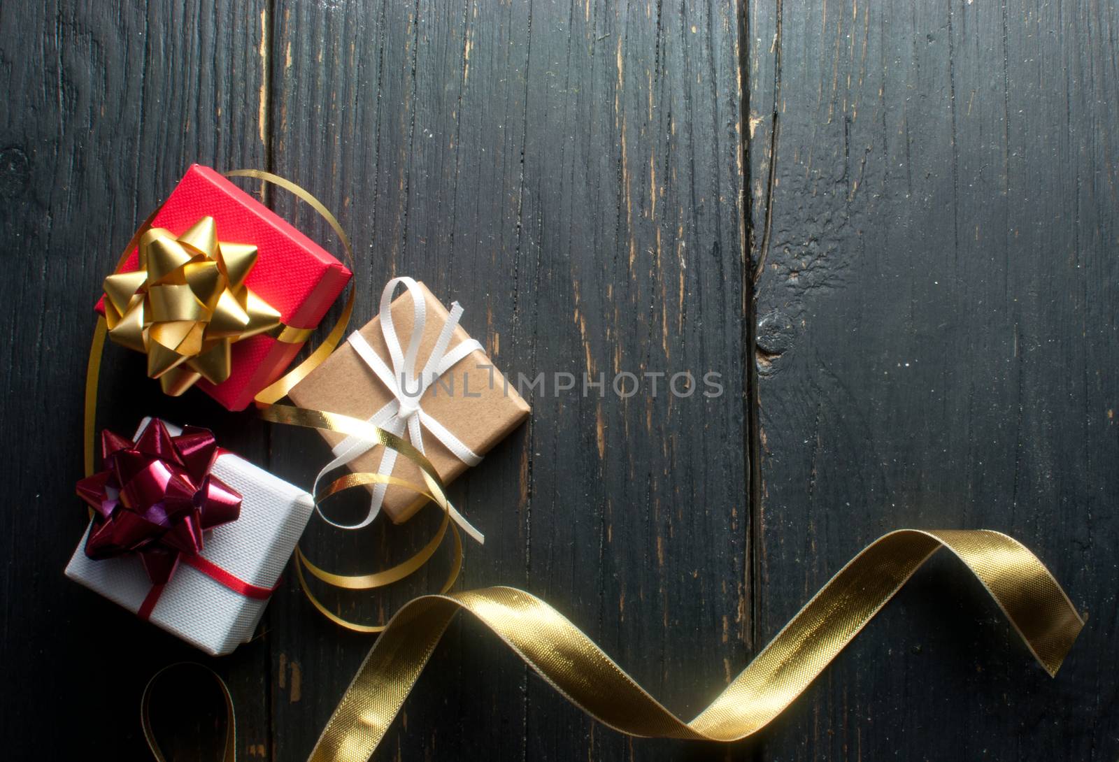 Christmas presents wrapped with ribbon over a wooden background