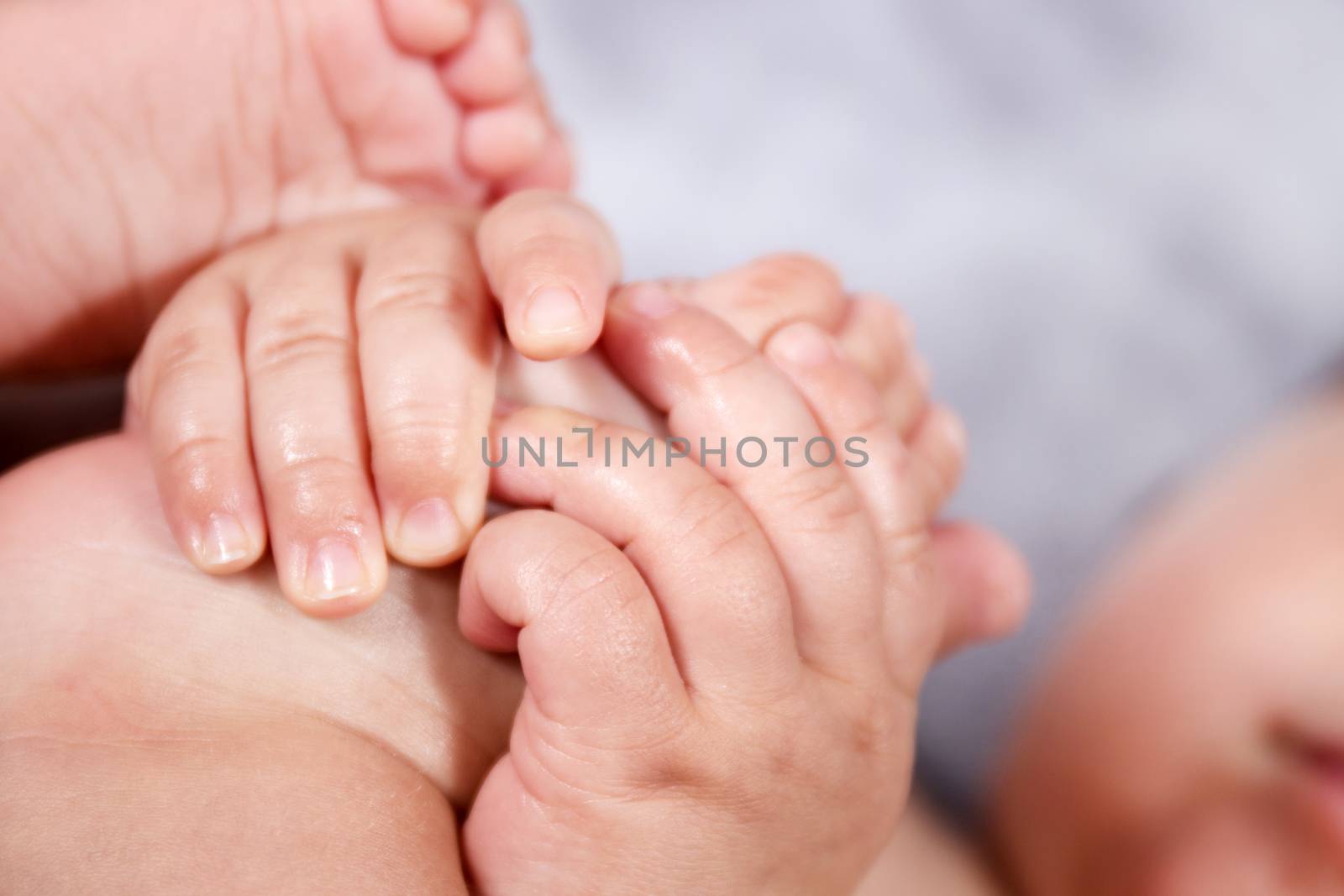 Close up of baby hands and feet of a newborn baby.