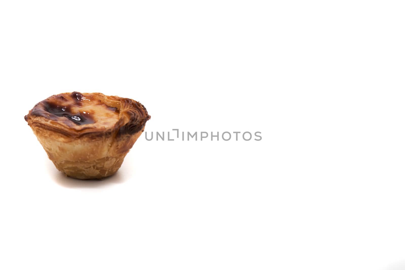 Famous Portuguese egg pastry tart called 'Pastel de Belem' isolated on white background.