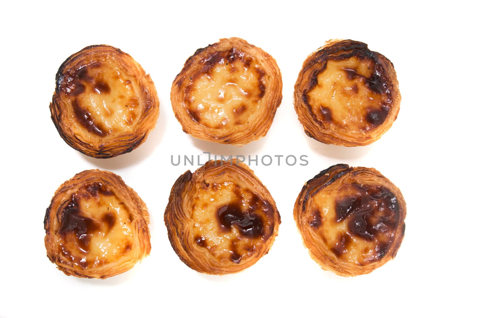 Famous Portuguese egg pastry tart called 'Pastel de Belem' isolated on white background.
