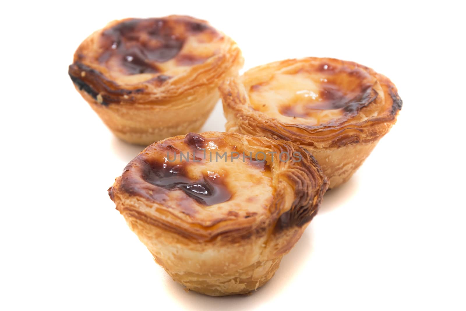 Famous Portuguese egg pastry tart called 'Pastel de Belem' isolated on white background.