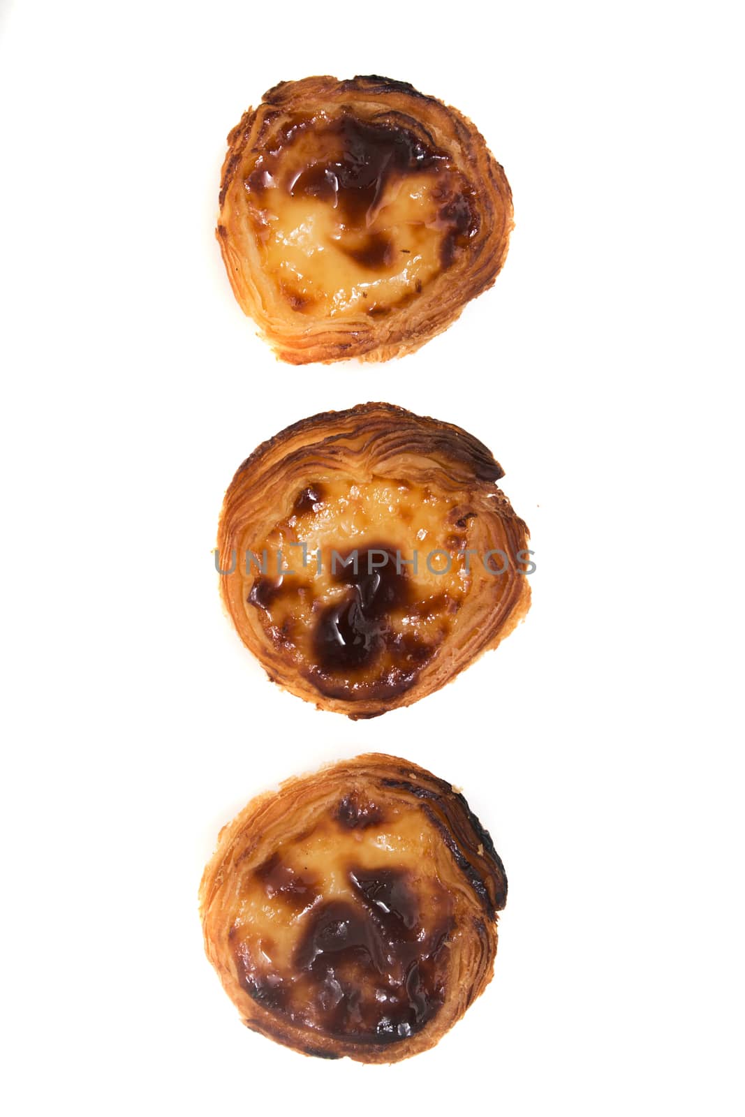 Famous Portuguese egg pastry tart called 'Pastel de Belem' isolated on white background.