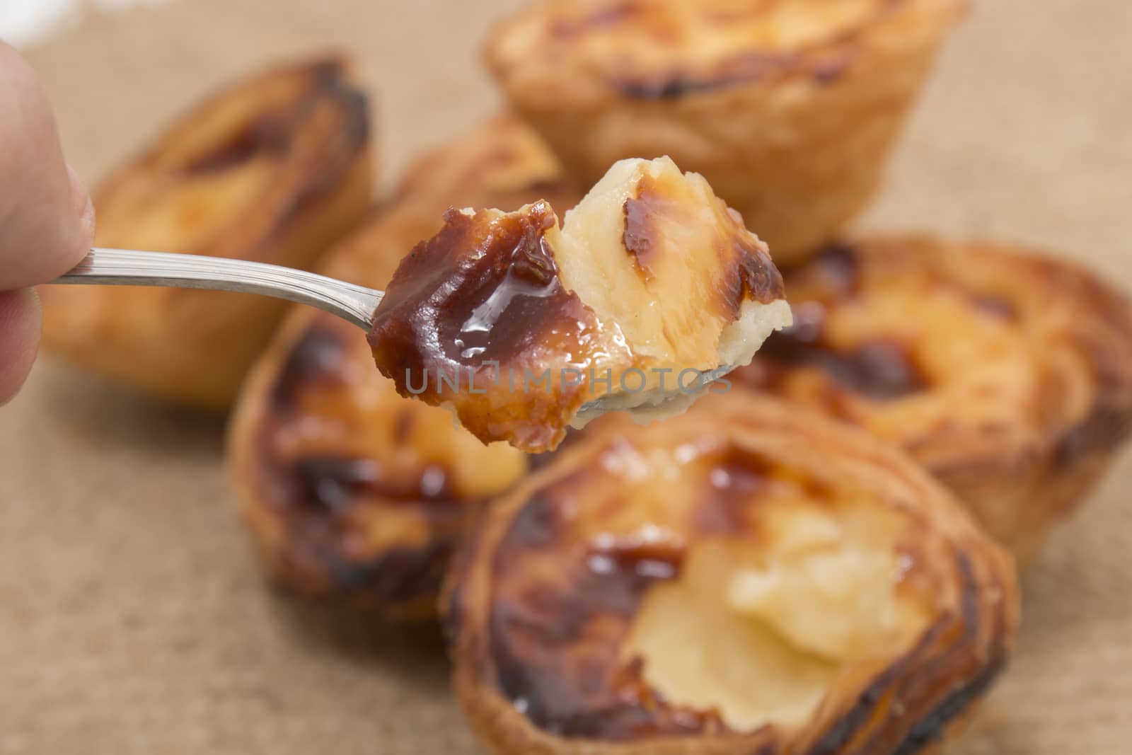 Famous Portuguese egg pastry tart called 'Pastel de Belem' on hessian fabric.