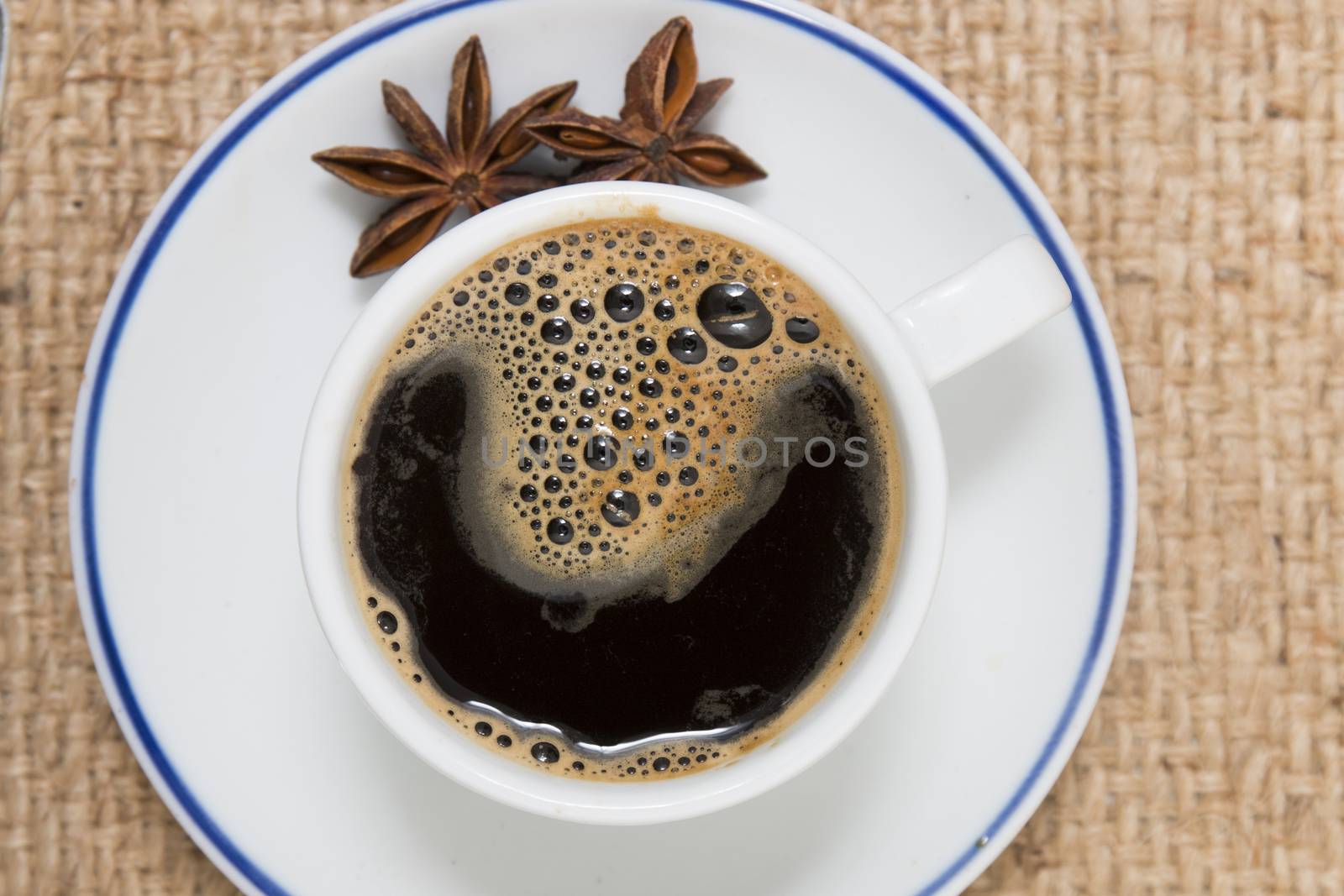 Top view of espresso coffee over a hessian fabric background.
