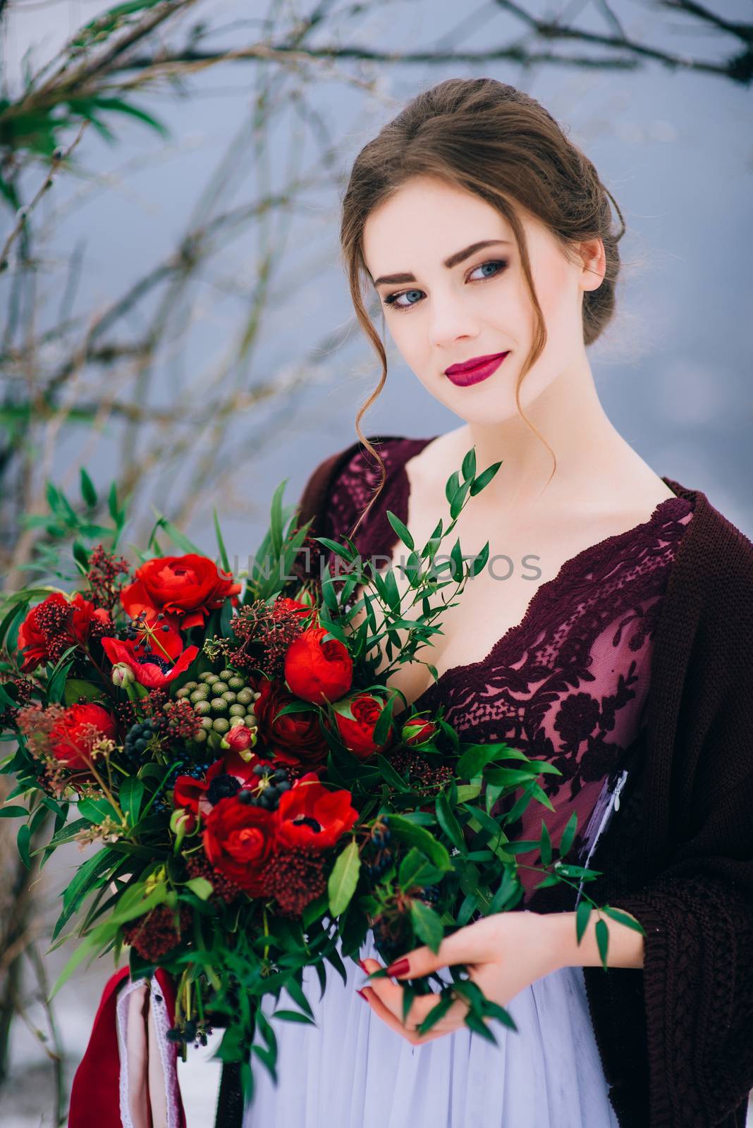 groom in a brown and bride in burgundy in the mountains Carpathians