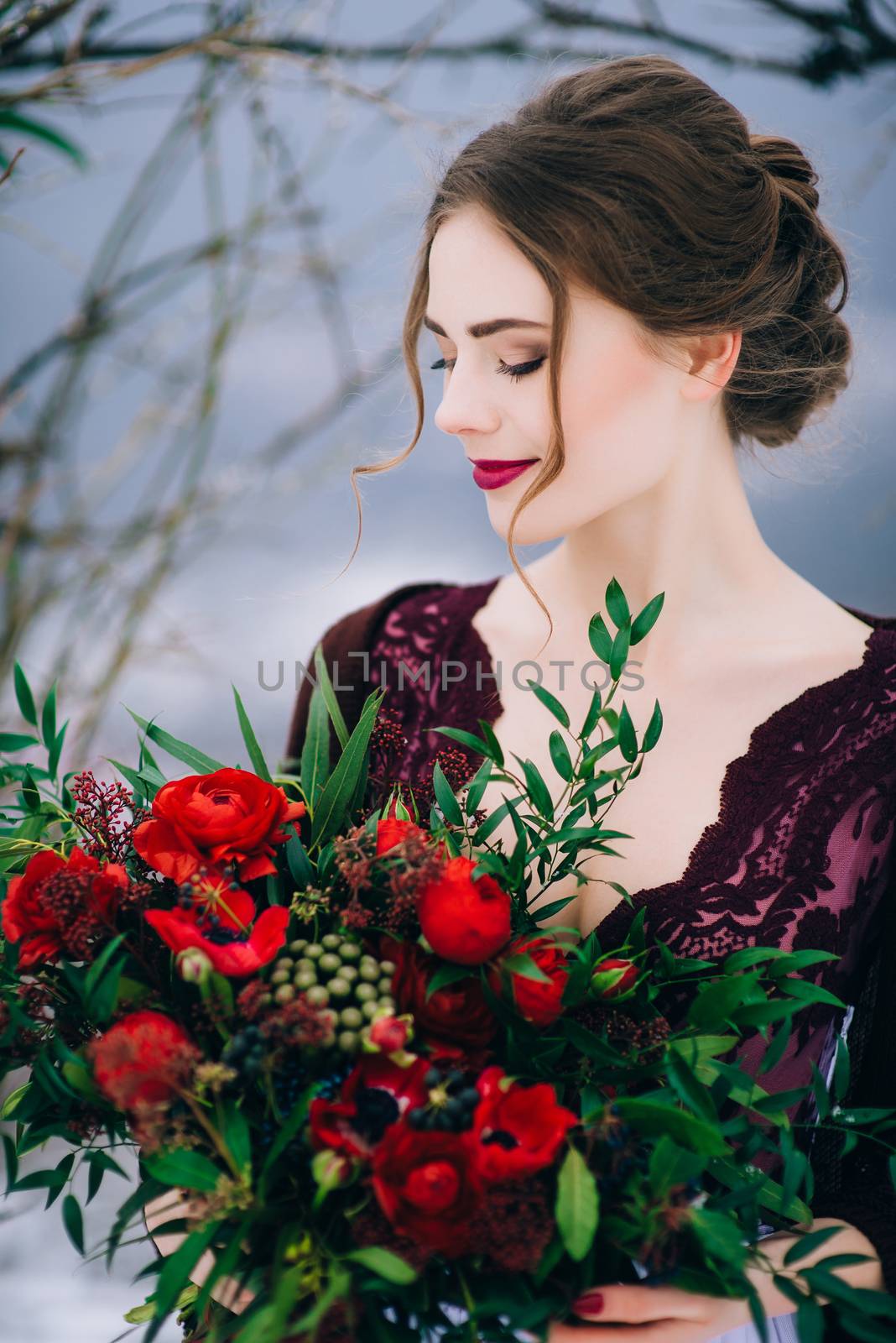 groom in a brown and bride in burgundy in the mountains Carpathians