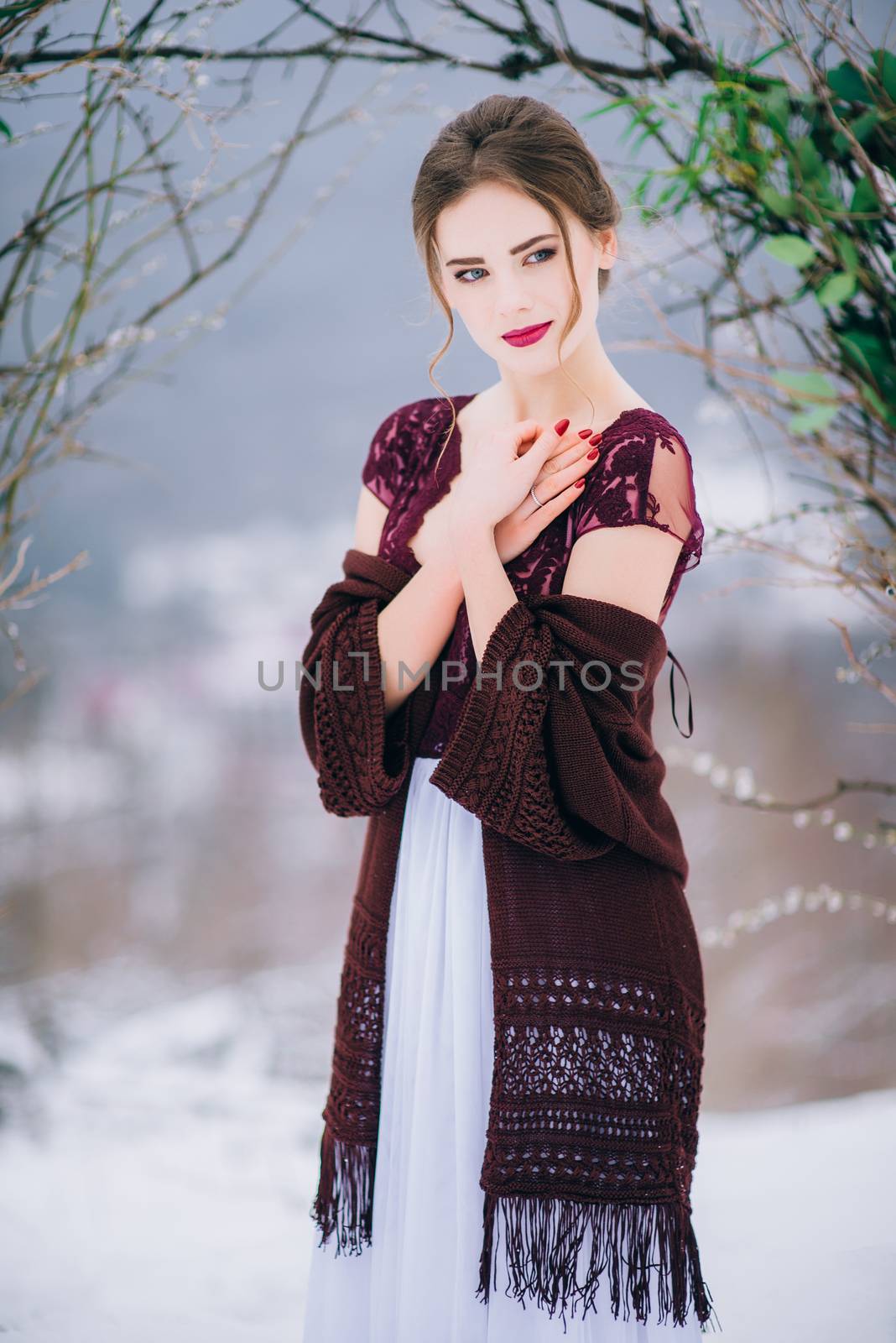 groom in a brown and bride in burgundy in the mountains Carpathians