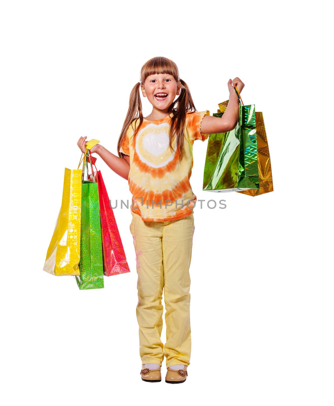 Smiling six years Girl holding presents bags isolated