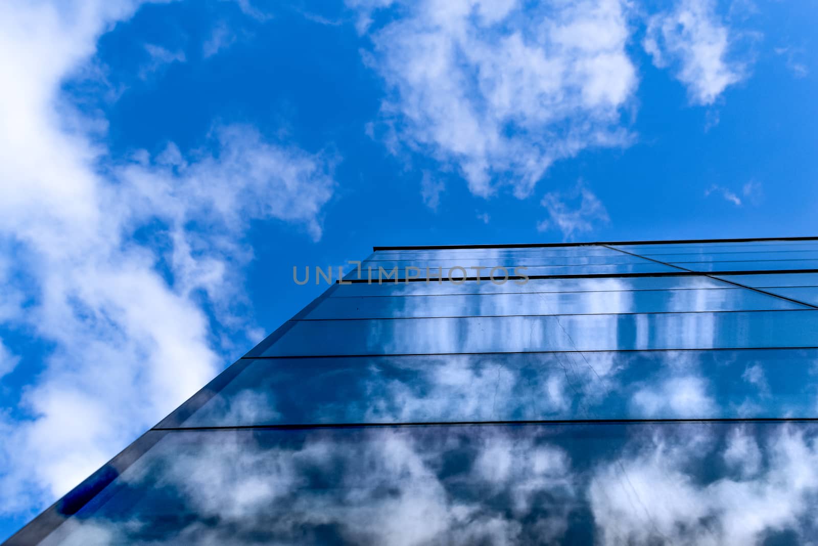 the sky reflected in the building of the great city buildings in the city