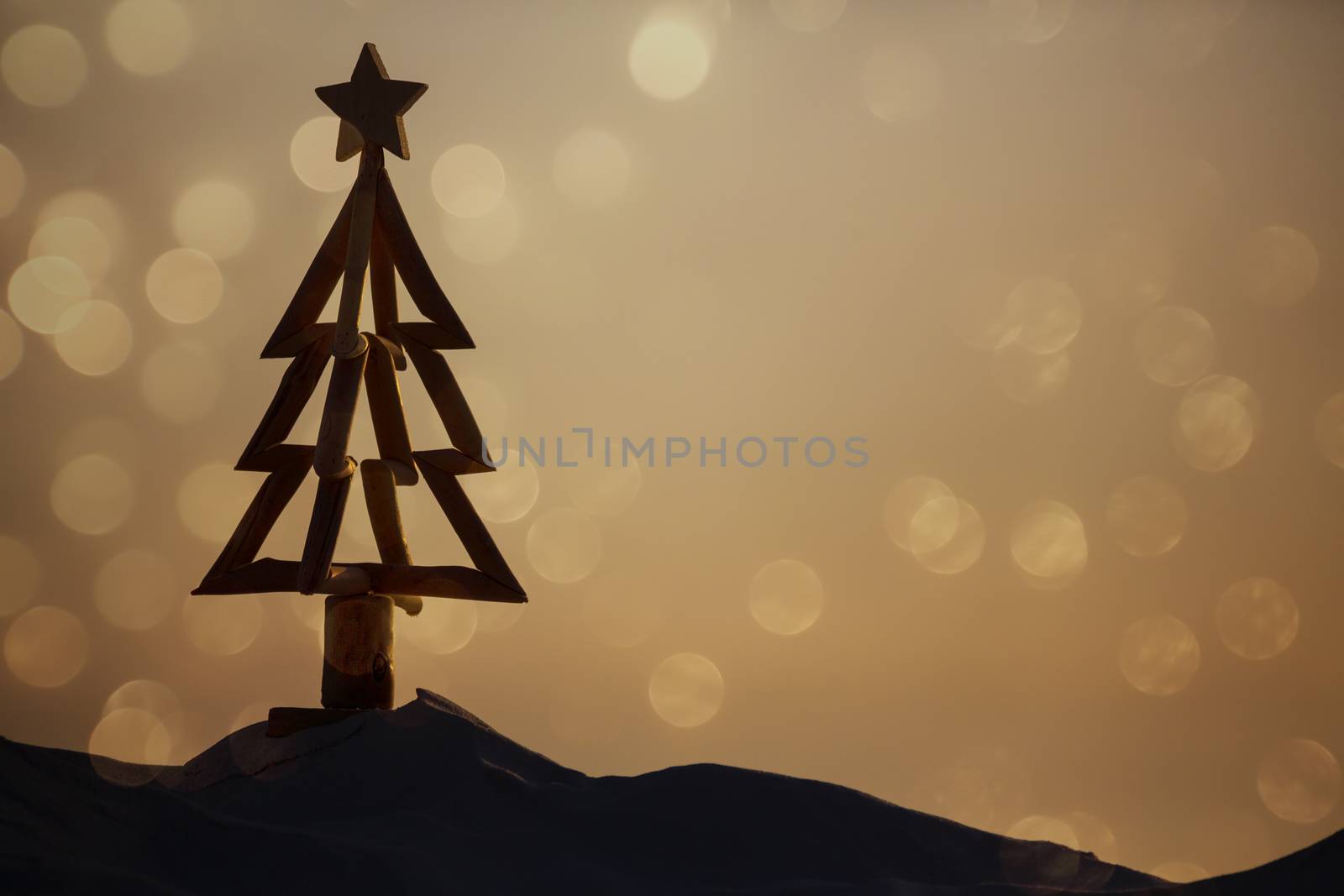 For Australians, Christmas is hot summer days and casual celebratiosns outdoors or down at the beach.  A diriftwood Christmas tree stands in the sand of the beach in the morning light with soft bokeh