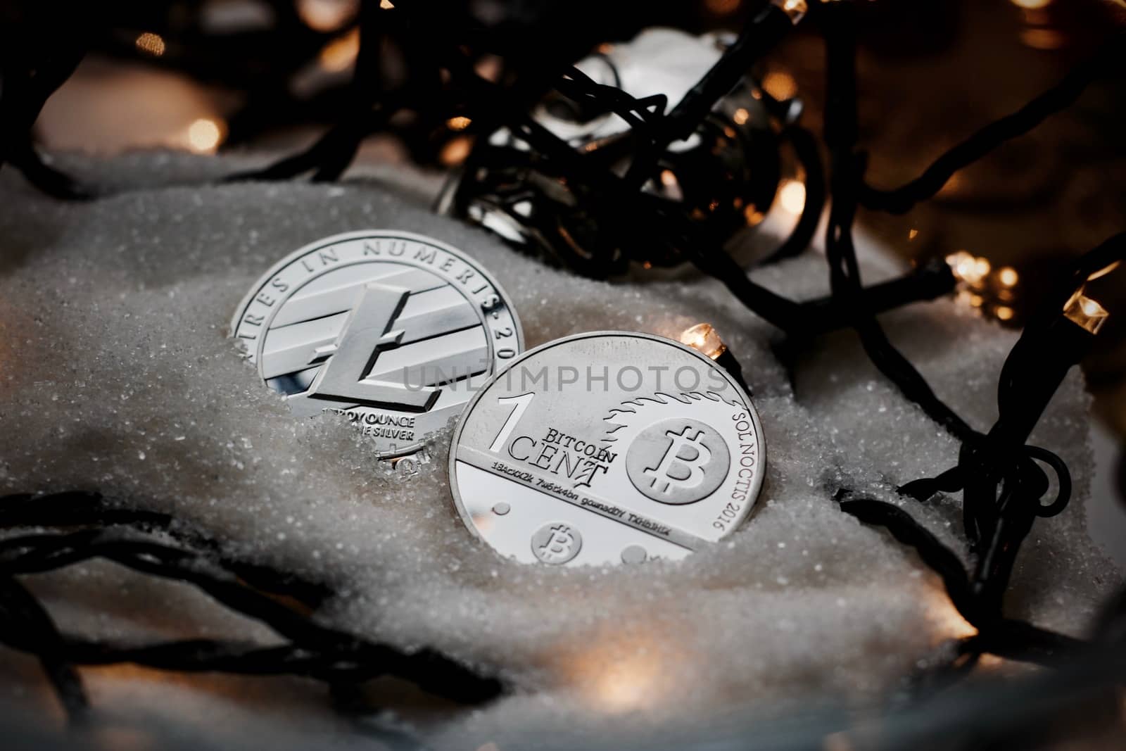 Digital currency physical metal bitcoin coin. Crypto currency christmas snow composition.