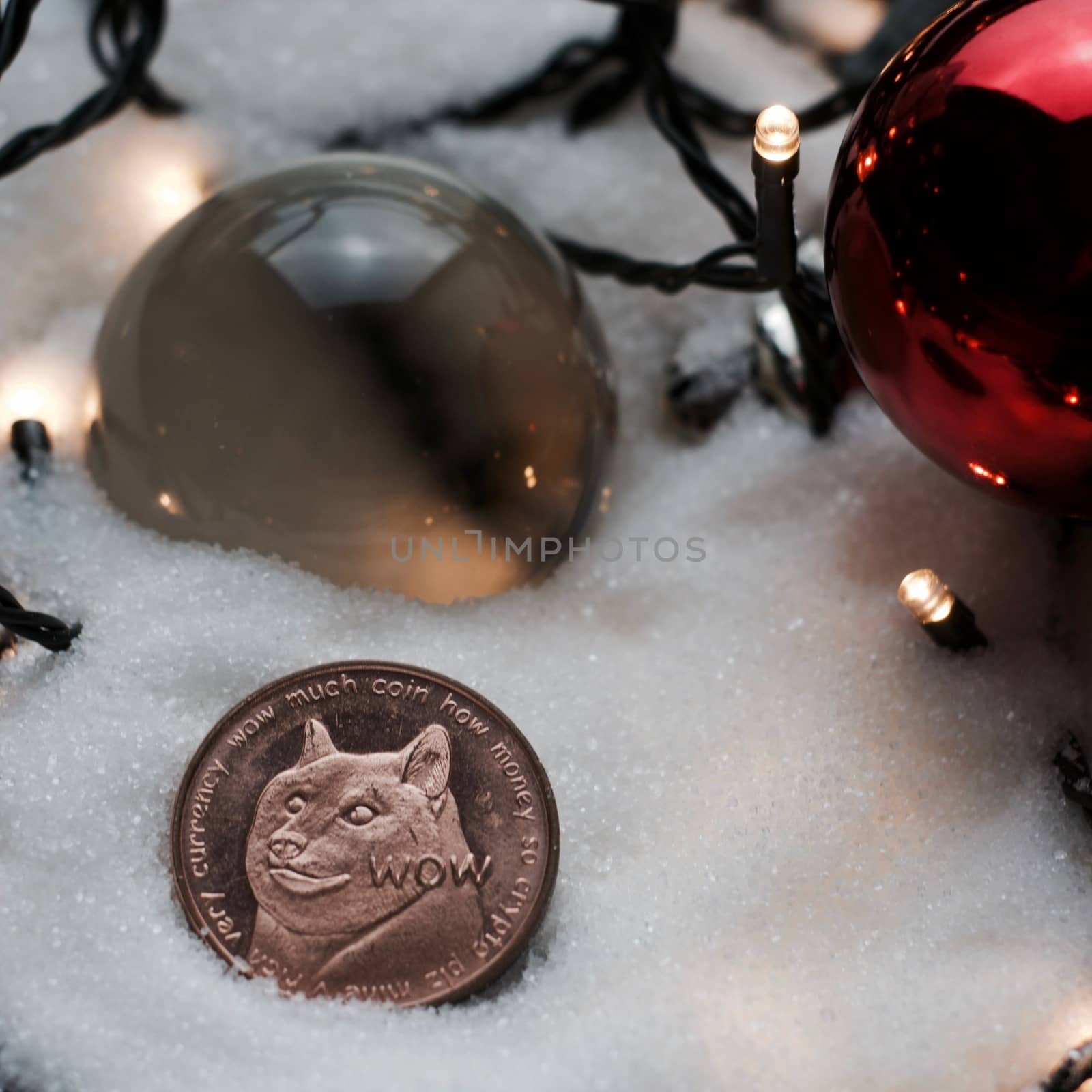 Digitl currency physical metal brass dogecoin coin. Christmas snow concept.