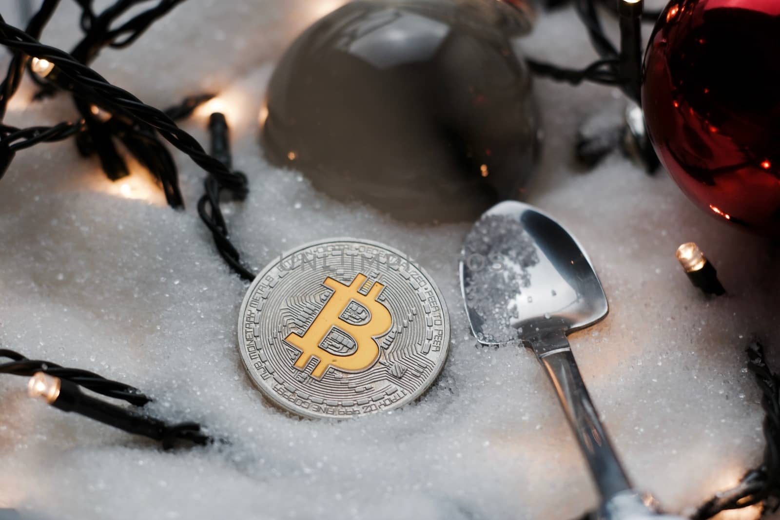 Digital currency physical metal bitcoin coin. Crypto currency christmas snow composition.