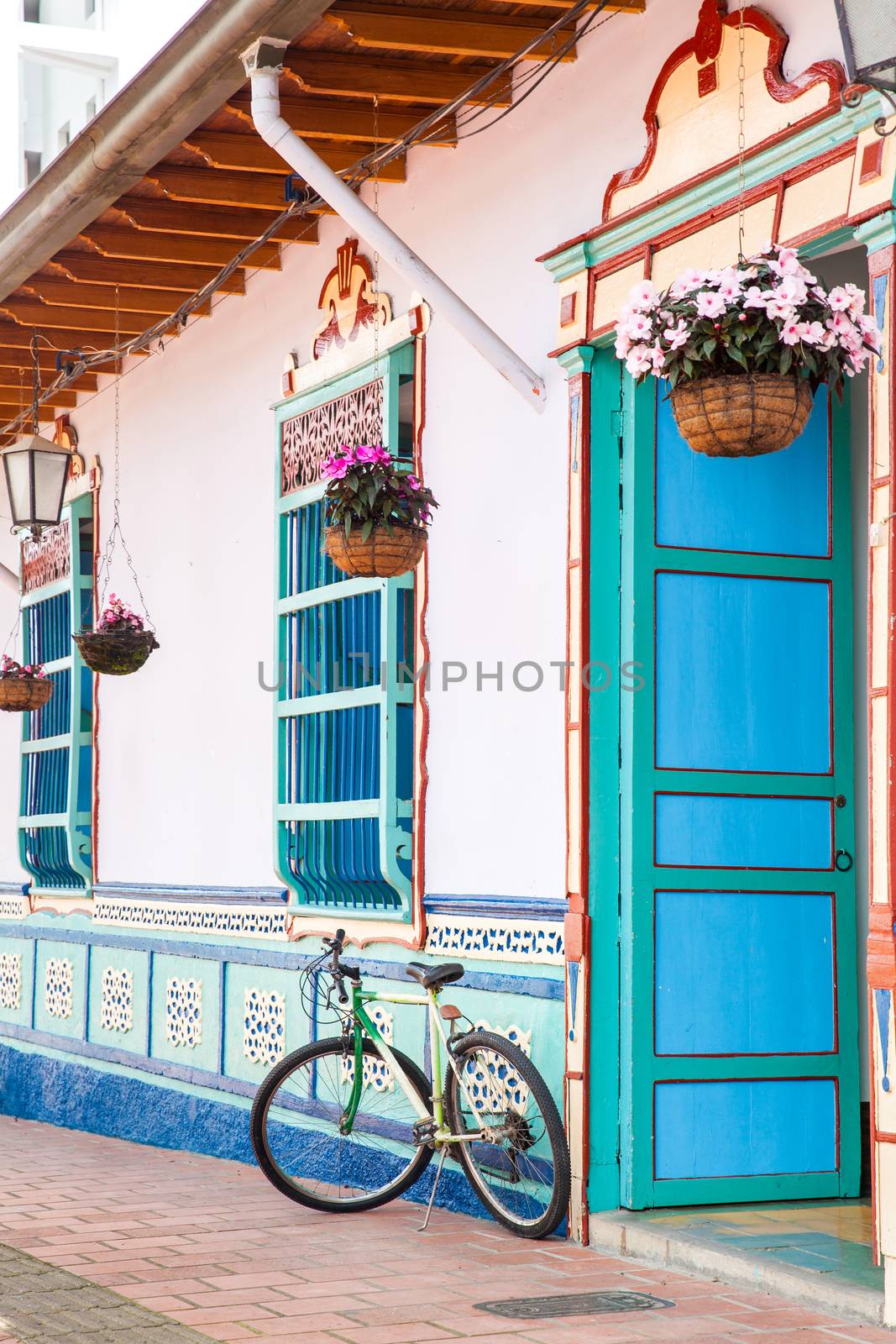 Bicycle next to a beautiful blue and white house at Guatape, Colombia
