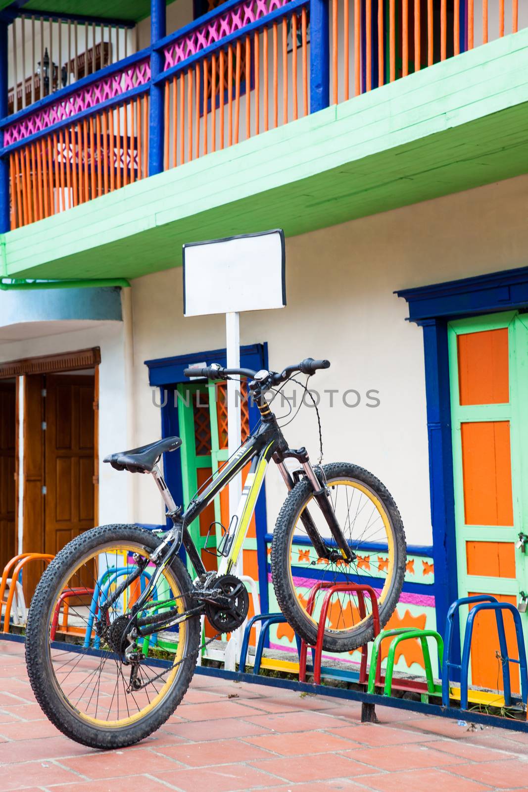 Lonely bicycle parked on a colorful rack by anamejia18