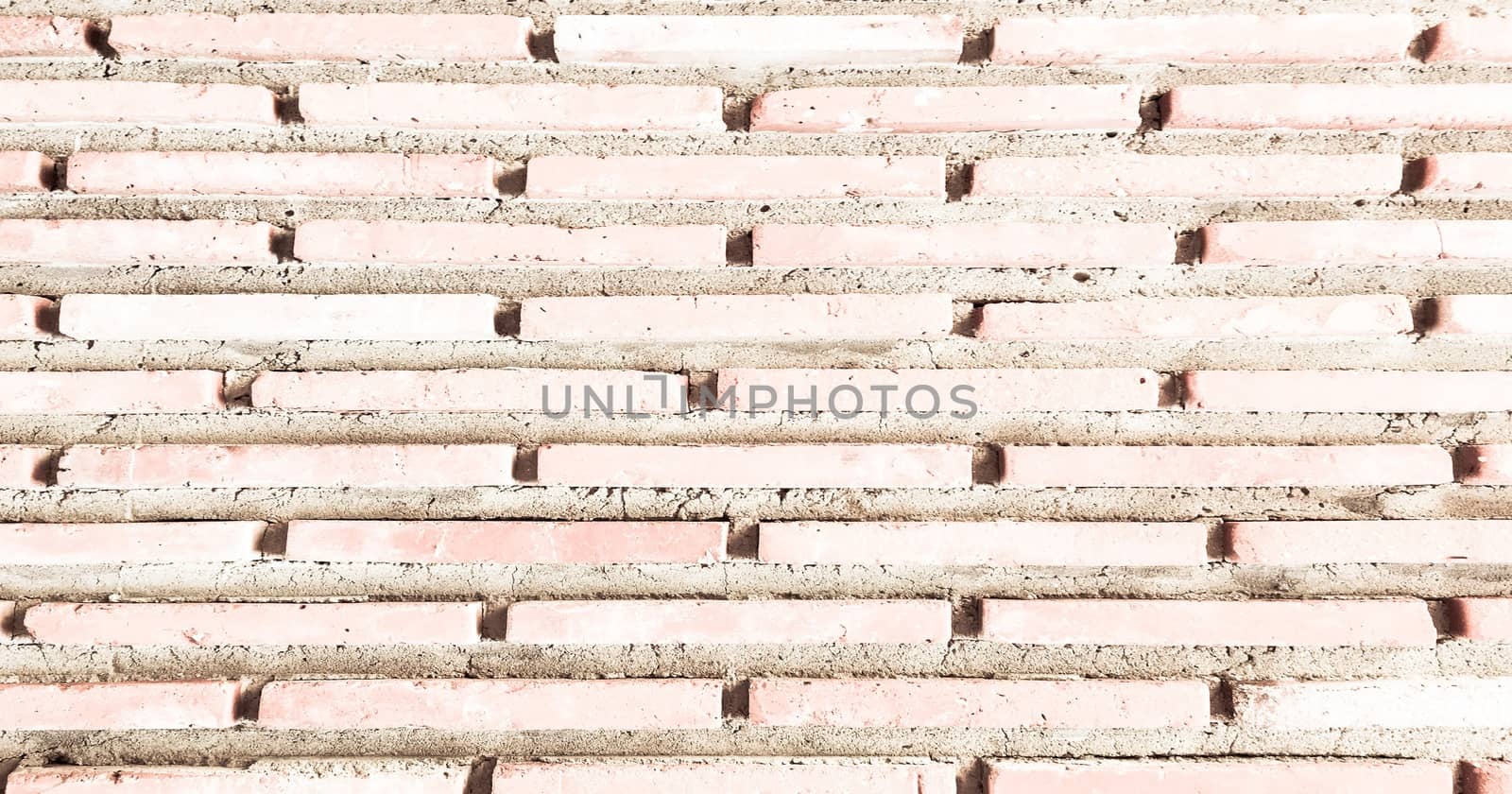 Grungy painted brick wall texture as background. Cracked concrete vintage brick wall background, old painted wall. Background brick painting