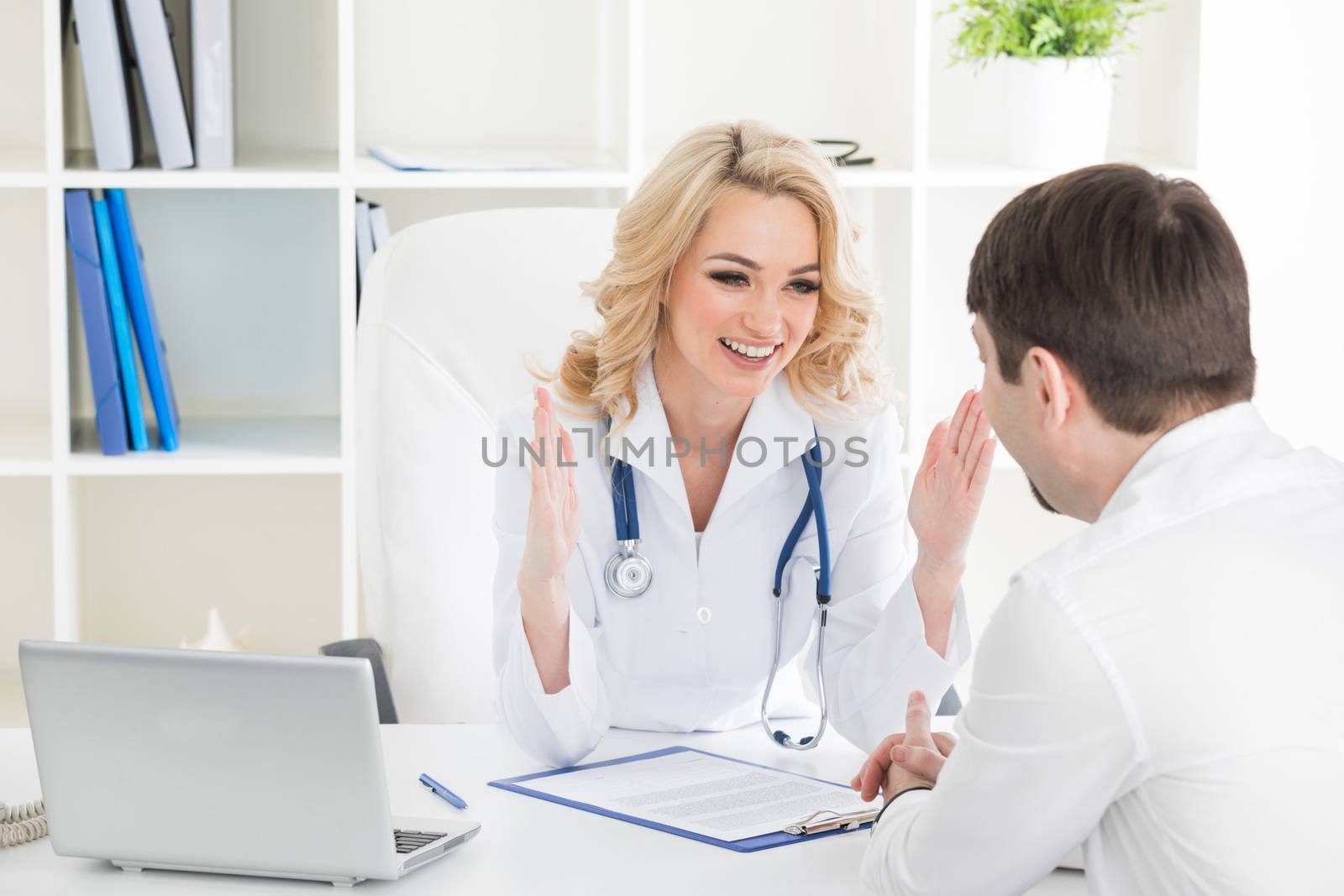 Doctor consulting patient in a clinical office