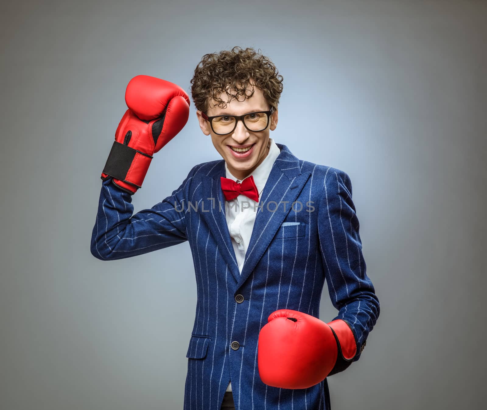 Businessman in boxing gloves by ALotOfPeople