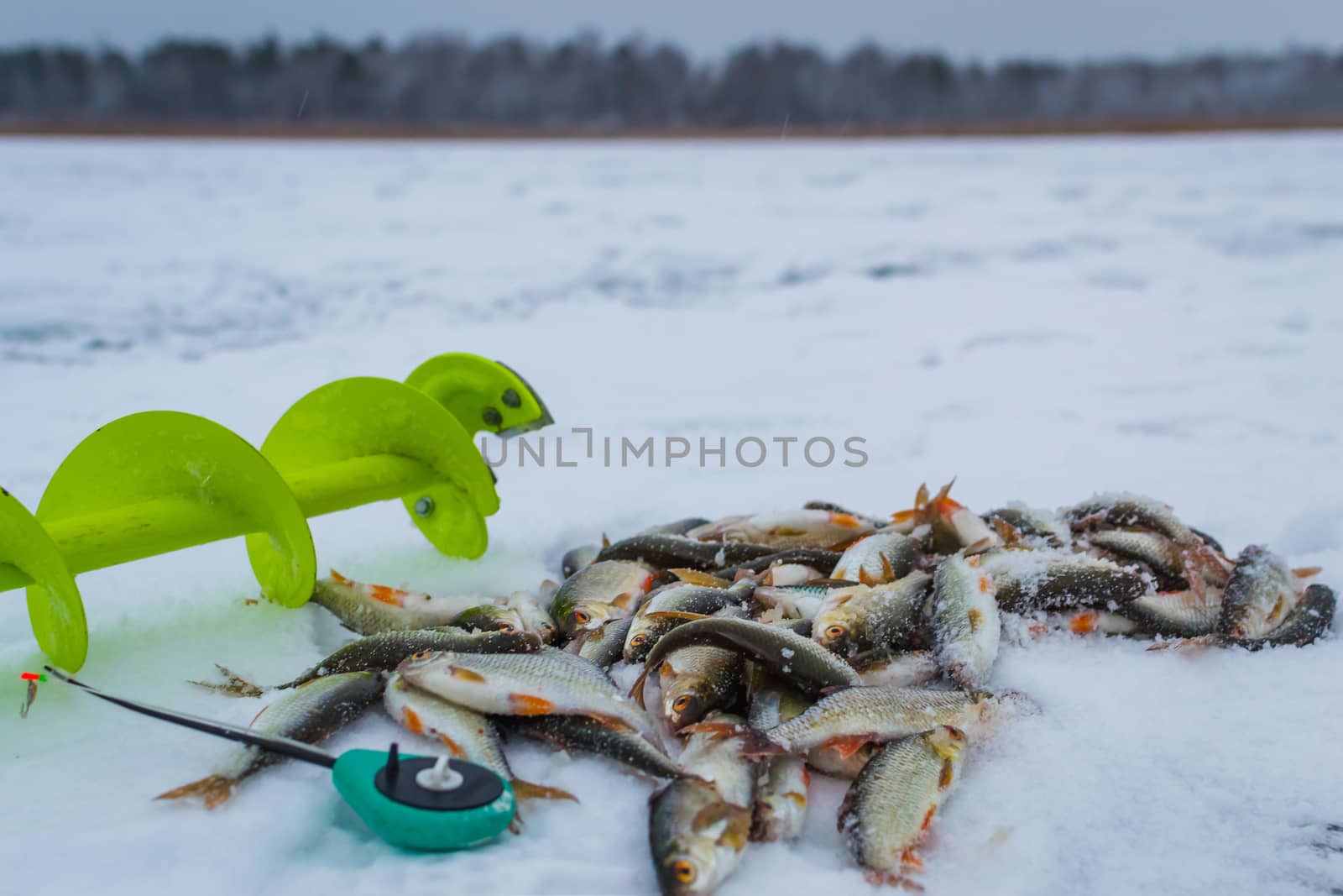 Fishing ice auger at dawn fishing drill ice beautiful sky