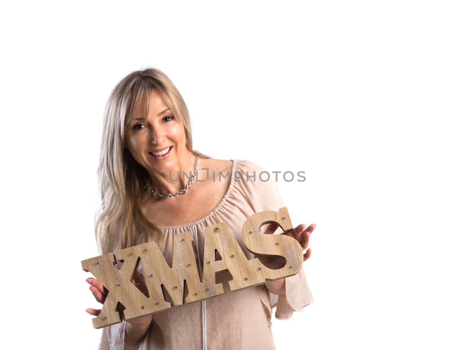 Smiling woman holding Xmas rustic wooden letters.  Christmas seasonal, space for copy