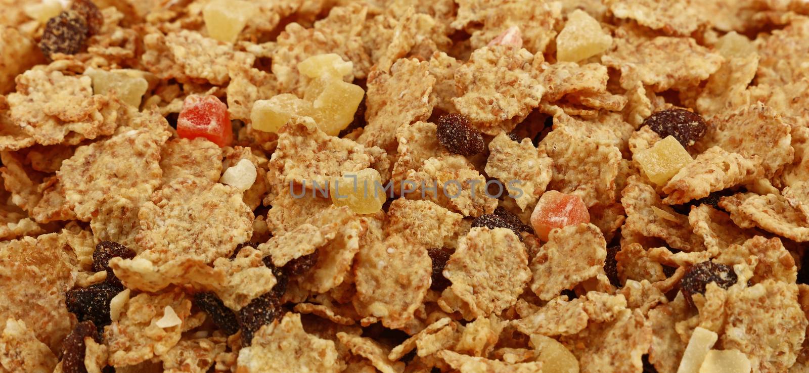 Breakfast granola muesli with dried fruits close up pattern background, low angle view, selective focus