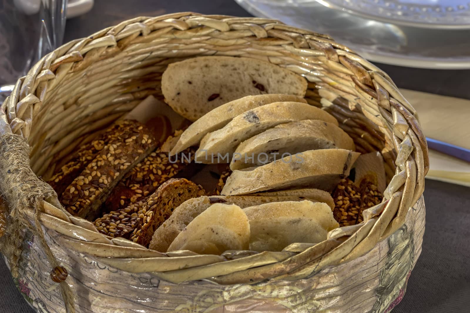 Bread in basket. Slices roll white bread and whole grain bread in the basket served on the table 