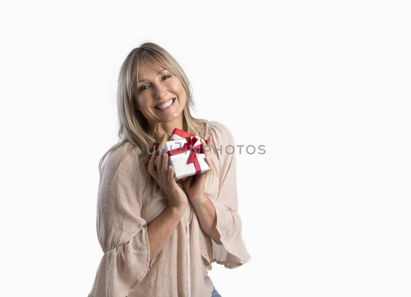 Female holding birthday or Christmas presents wrapped and tied with ribbon.  She is smiling and on a white background.