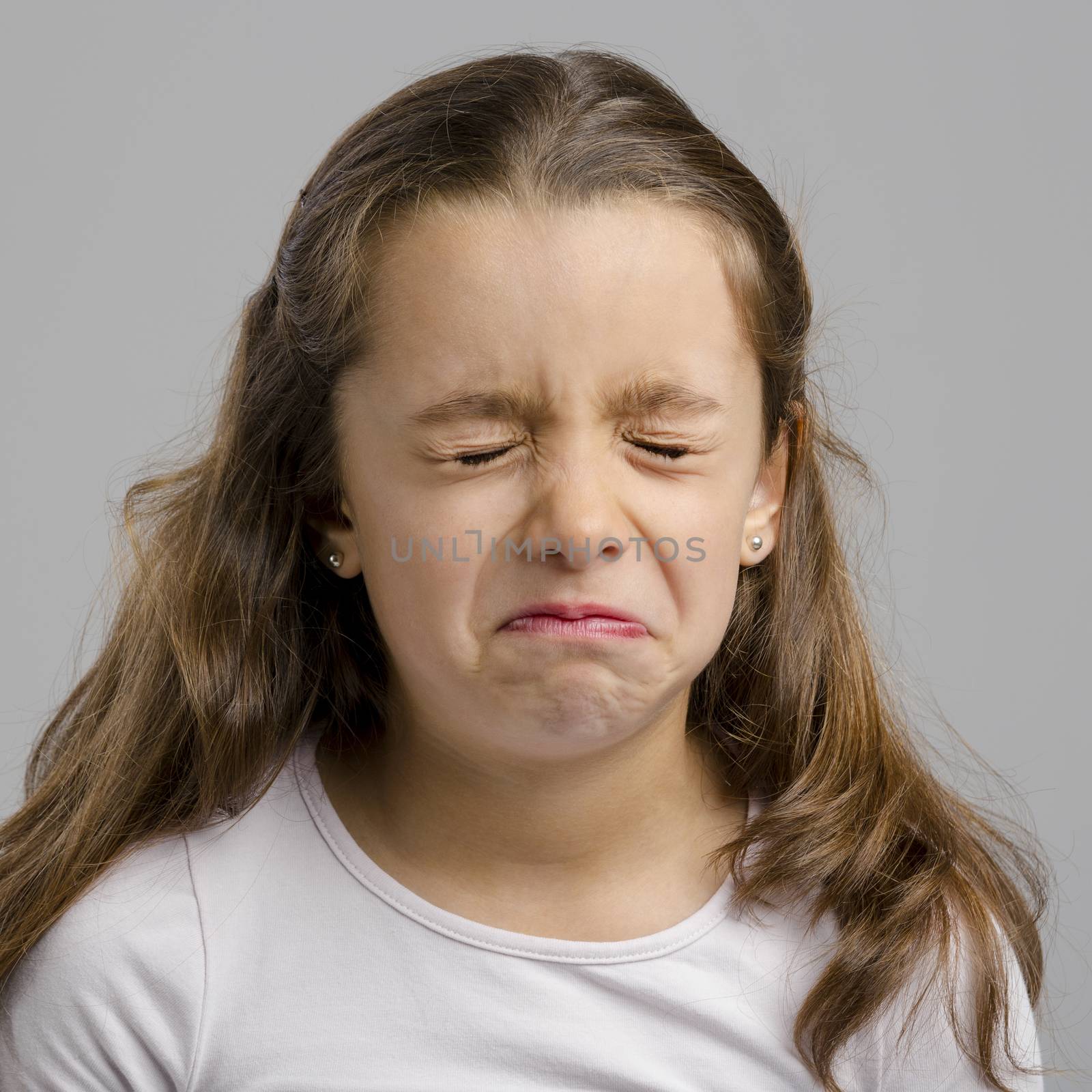 Studio portrait of a little girl crying