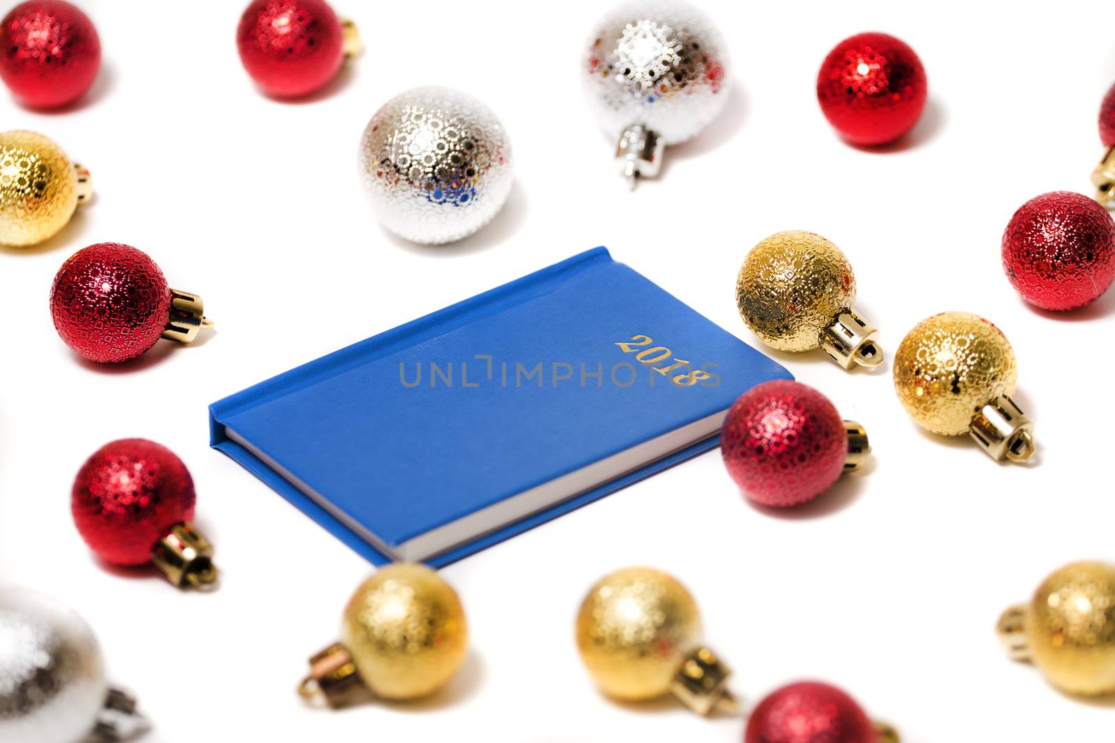 2018 agenda surrounded with xmas balls isolated on a white background.