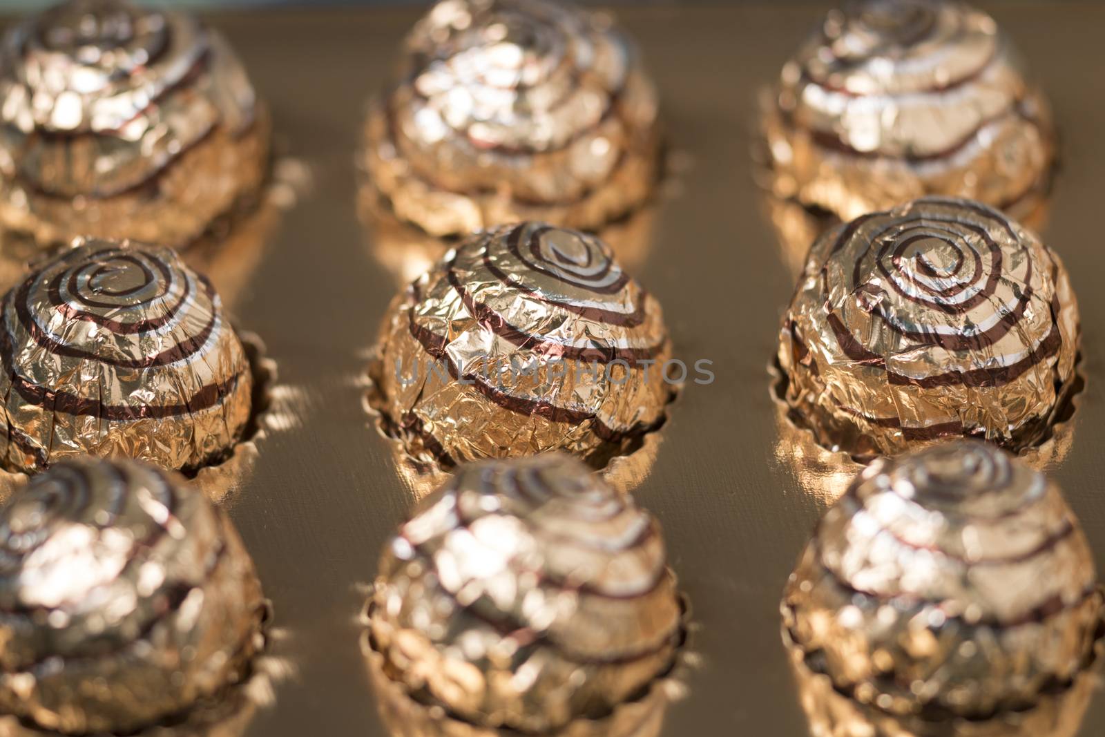 Box of sweet round chocolate candies for christmas celebrations.