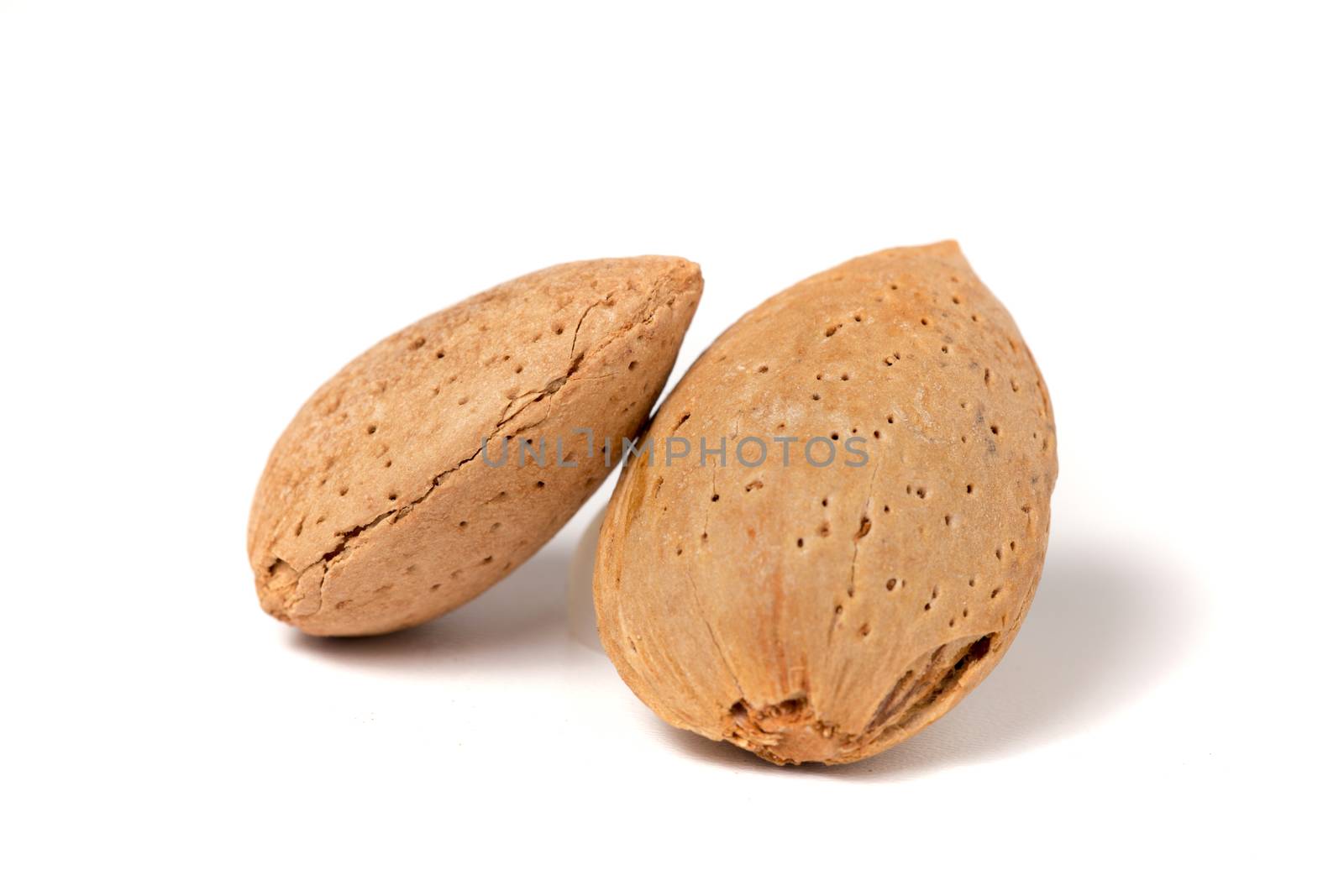 Two sweet almonds isolated on a white background.