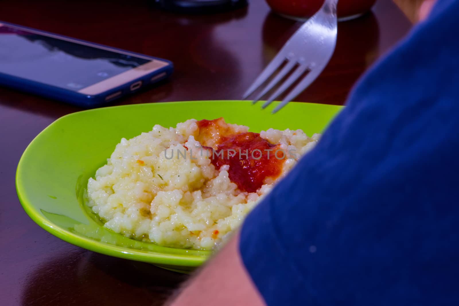 lonely person eating the rice with tomato sos at his break time