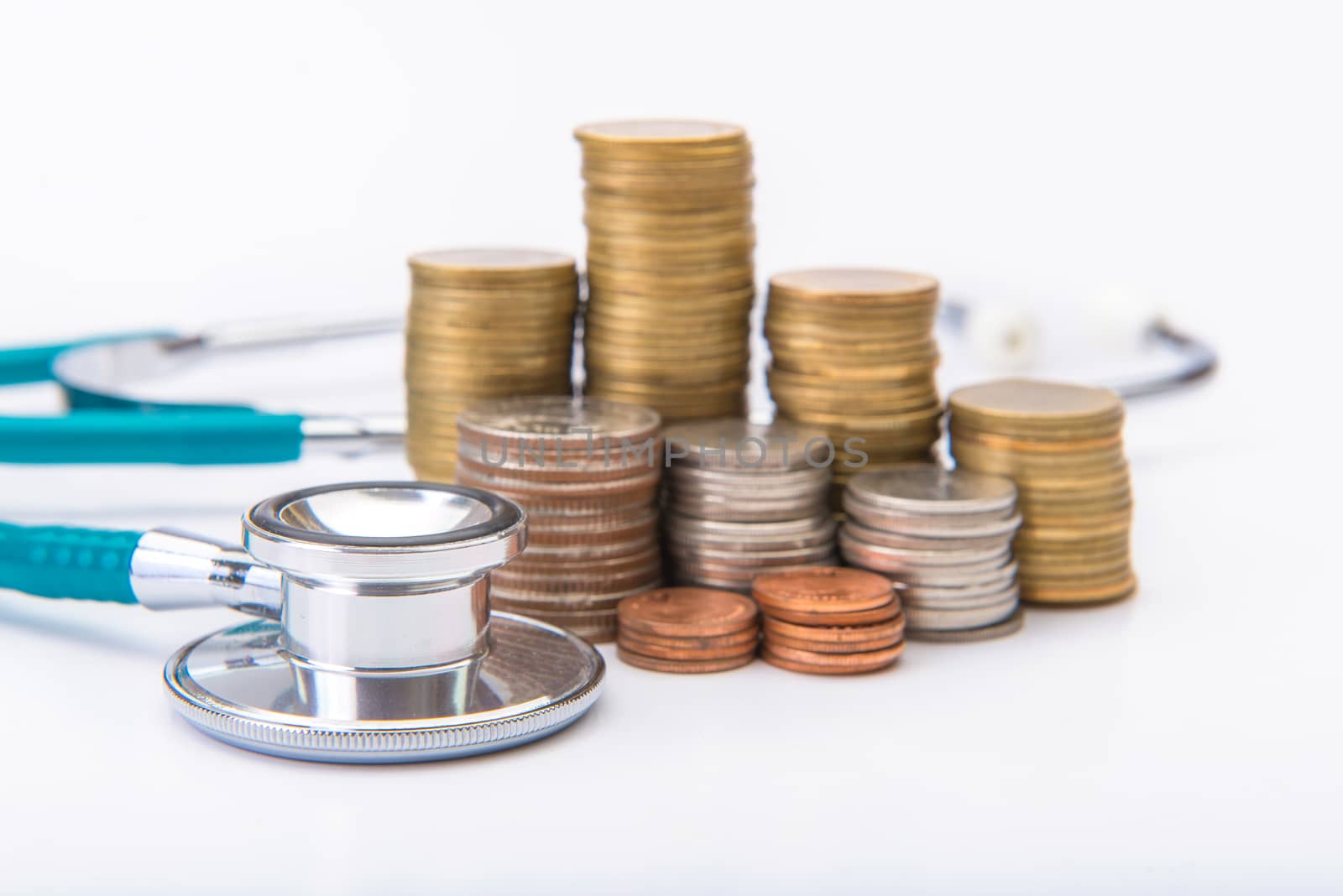 coin stack growing business with medical instruments stethoscope, Saving money concept.