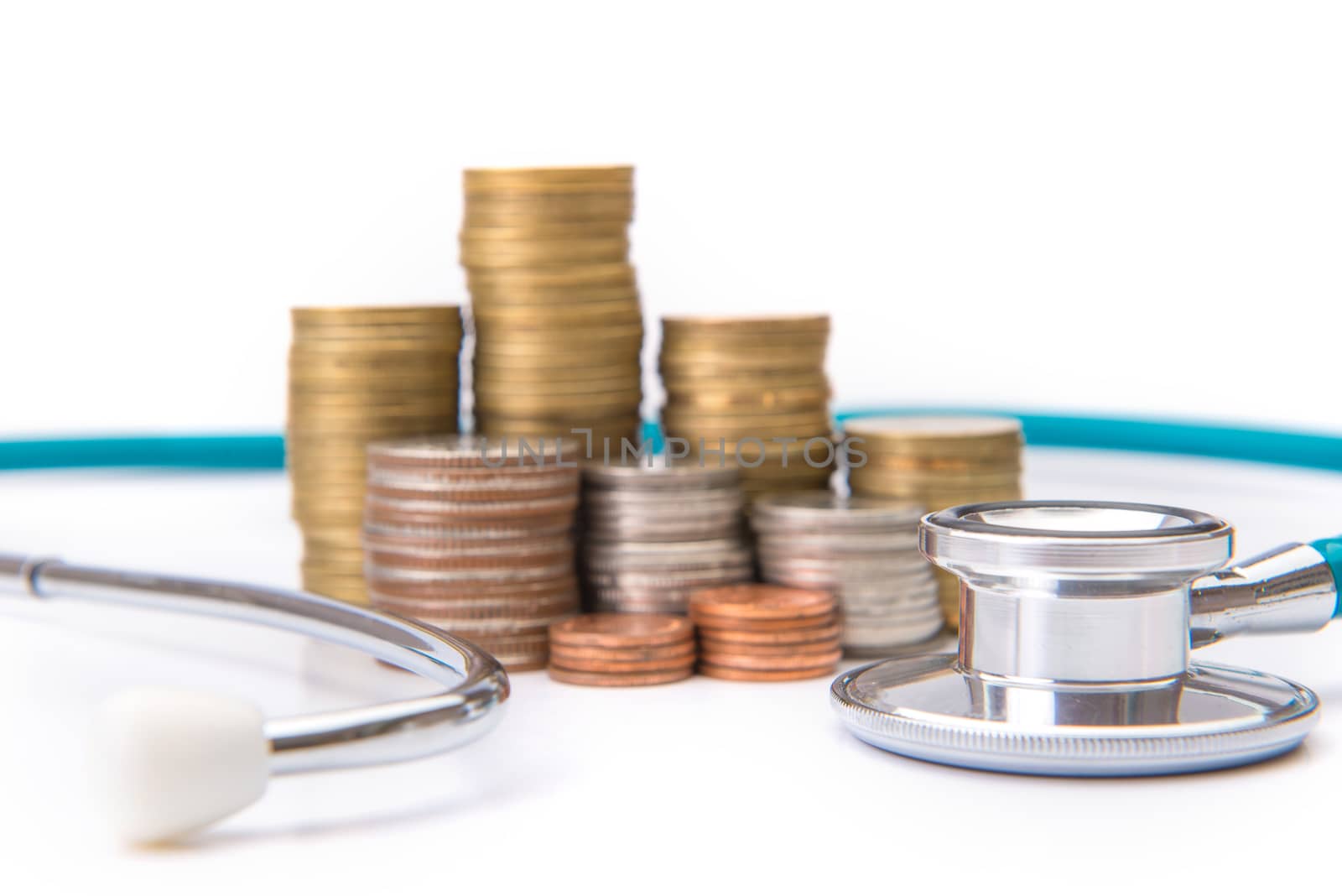 coin stack growing business with medical instruments stethoscope, Saving money concept.