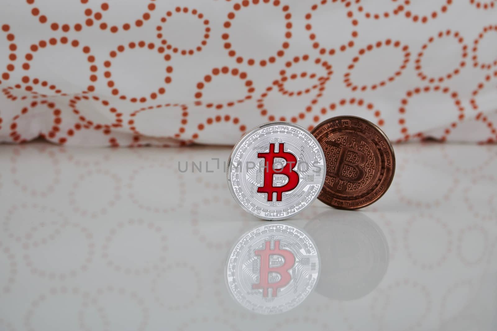 Cryptocurrency physical silver bitcoin coin and brass bitcoin on the white scene.