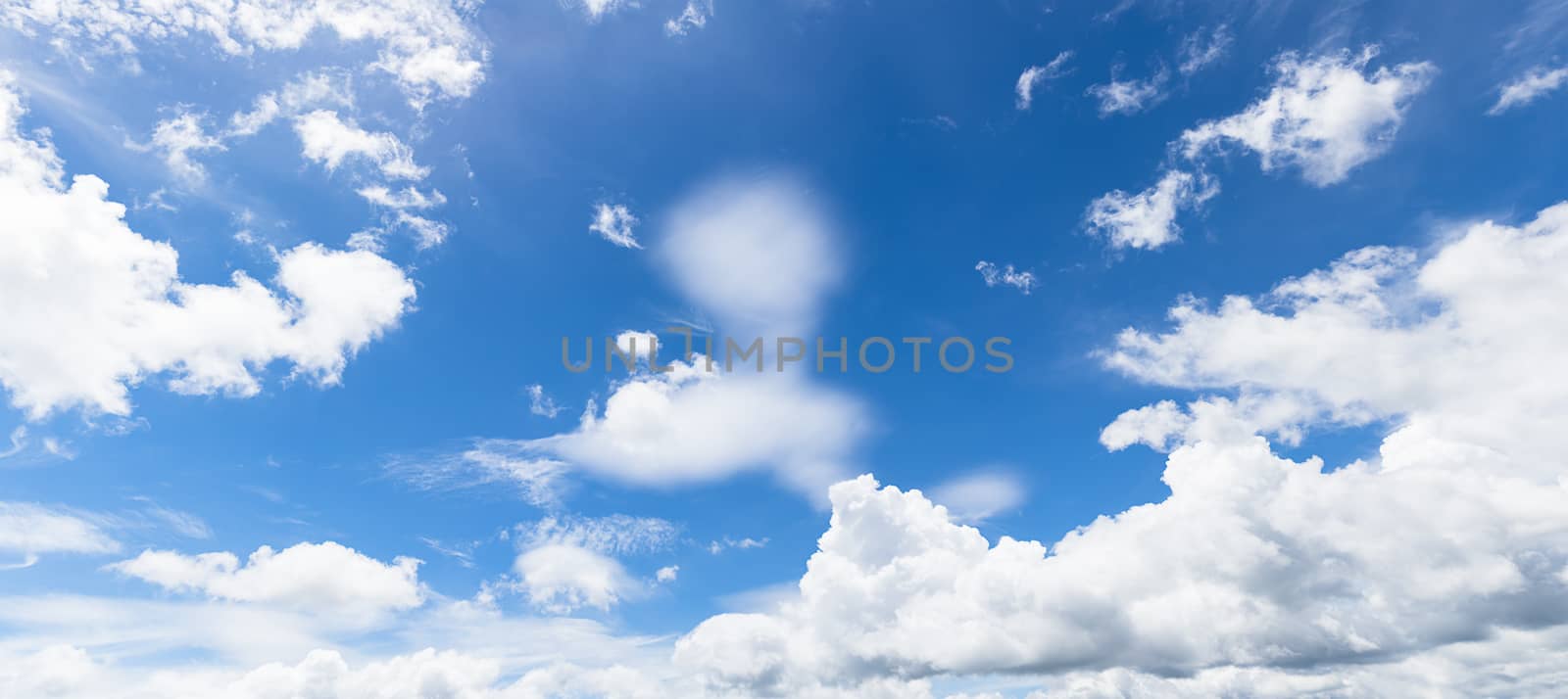 Panoramic white fluffy clouds in the blue sky, Fantastic soft white clouds against blue sky