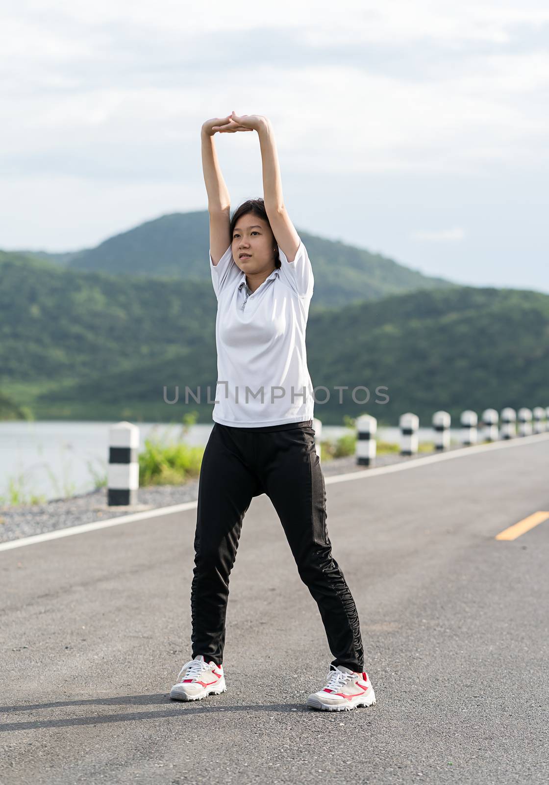 Woman short hair doing exercising outdoor by stoonn