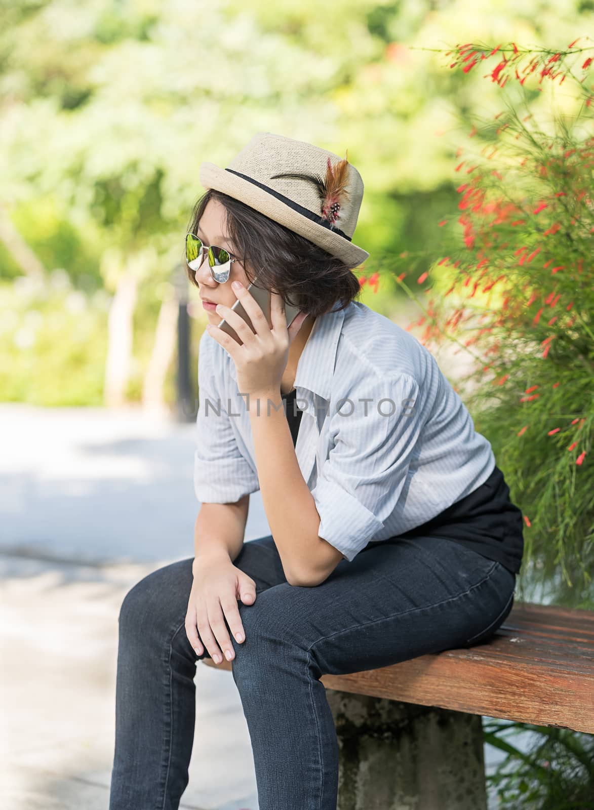 Women with short hair wearing hat in garden by stoonn