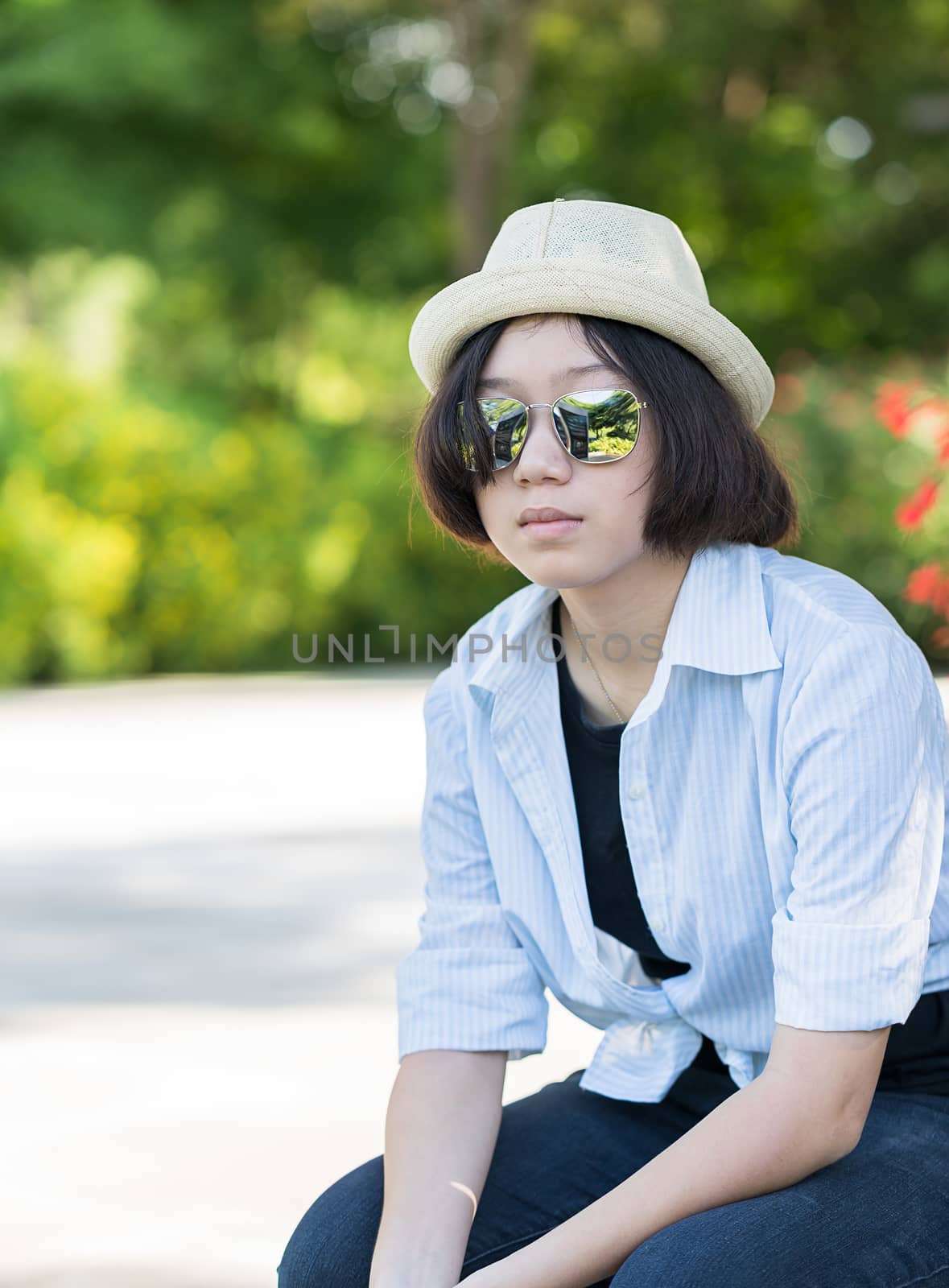 Women with short hair wearing hat in park by stoonn