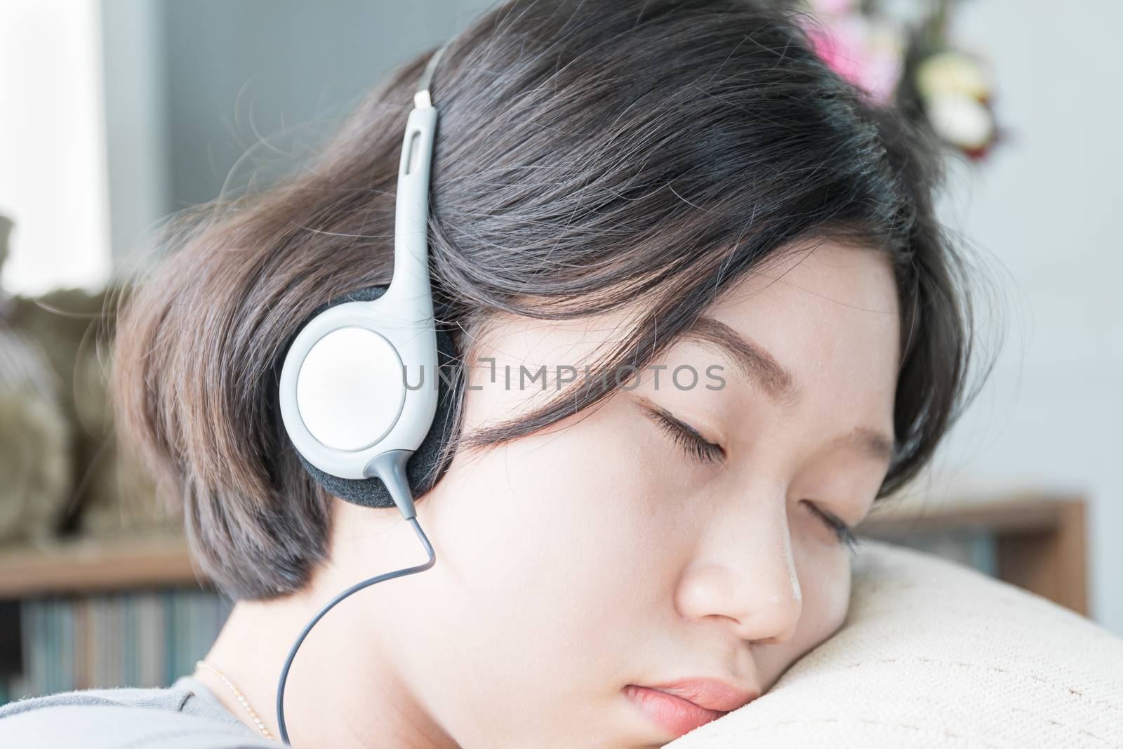 Young asian woman short hair listening music  by stoonn