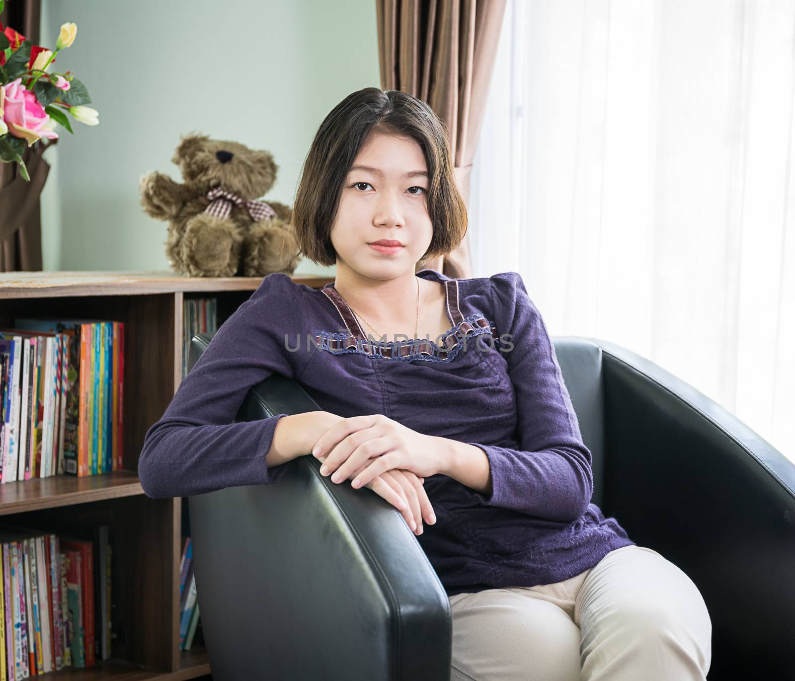 Close up beautiful young asian woman short hair relaxation by side the window in living room at home