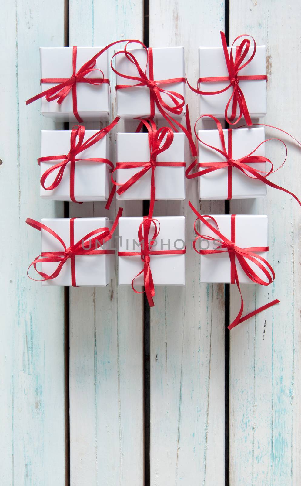 White gift boxes tied with red ribbon with background space