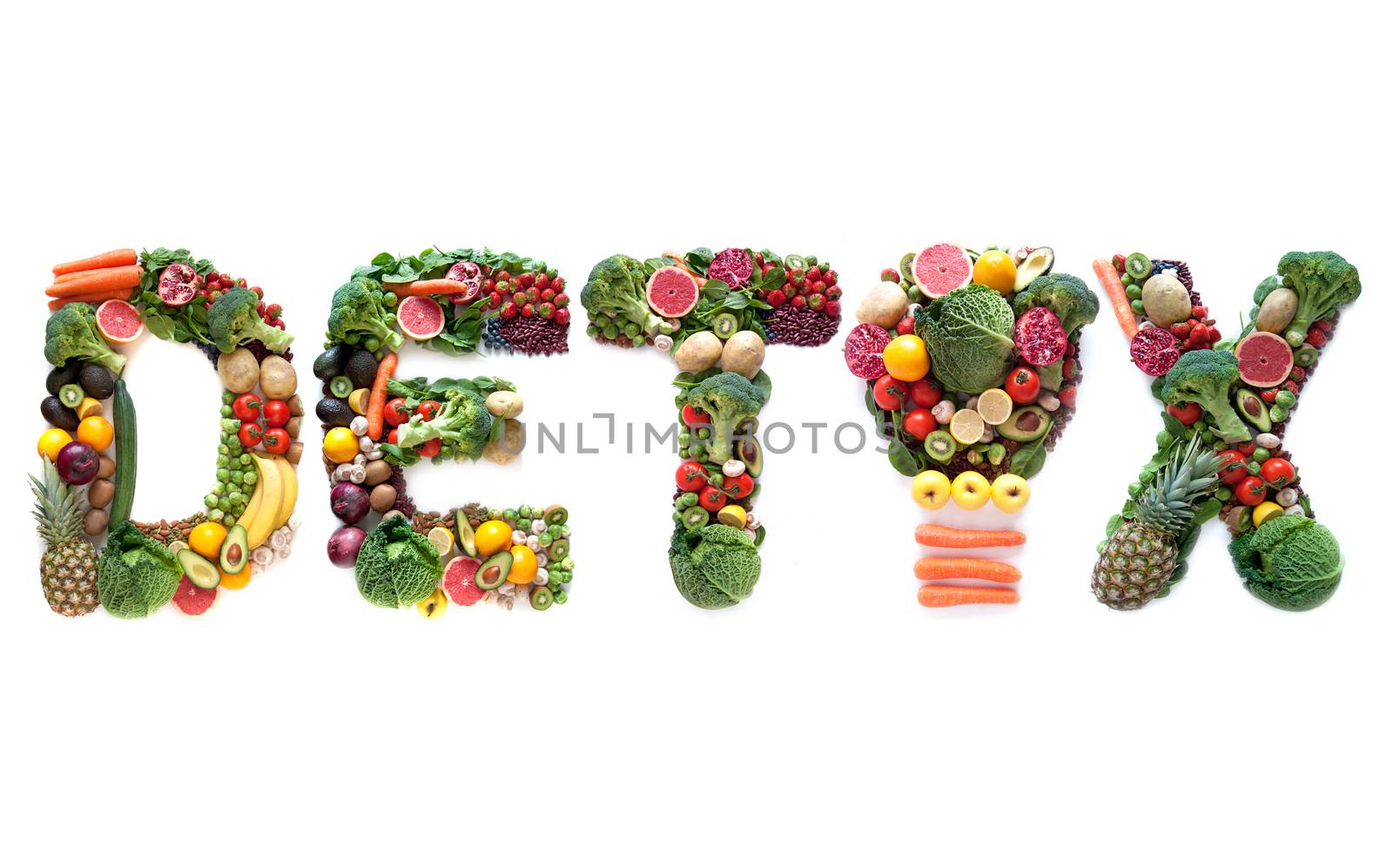 Detox spelt using large letters made of fruits and vegetables including a light bulb symbol