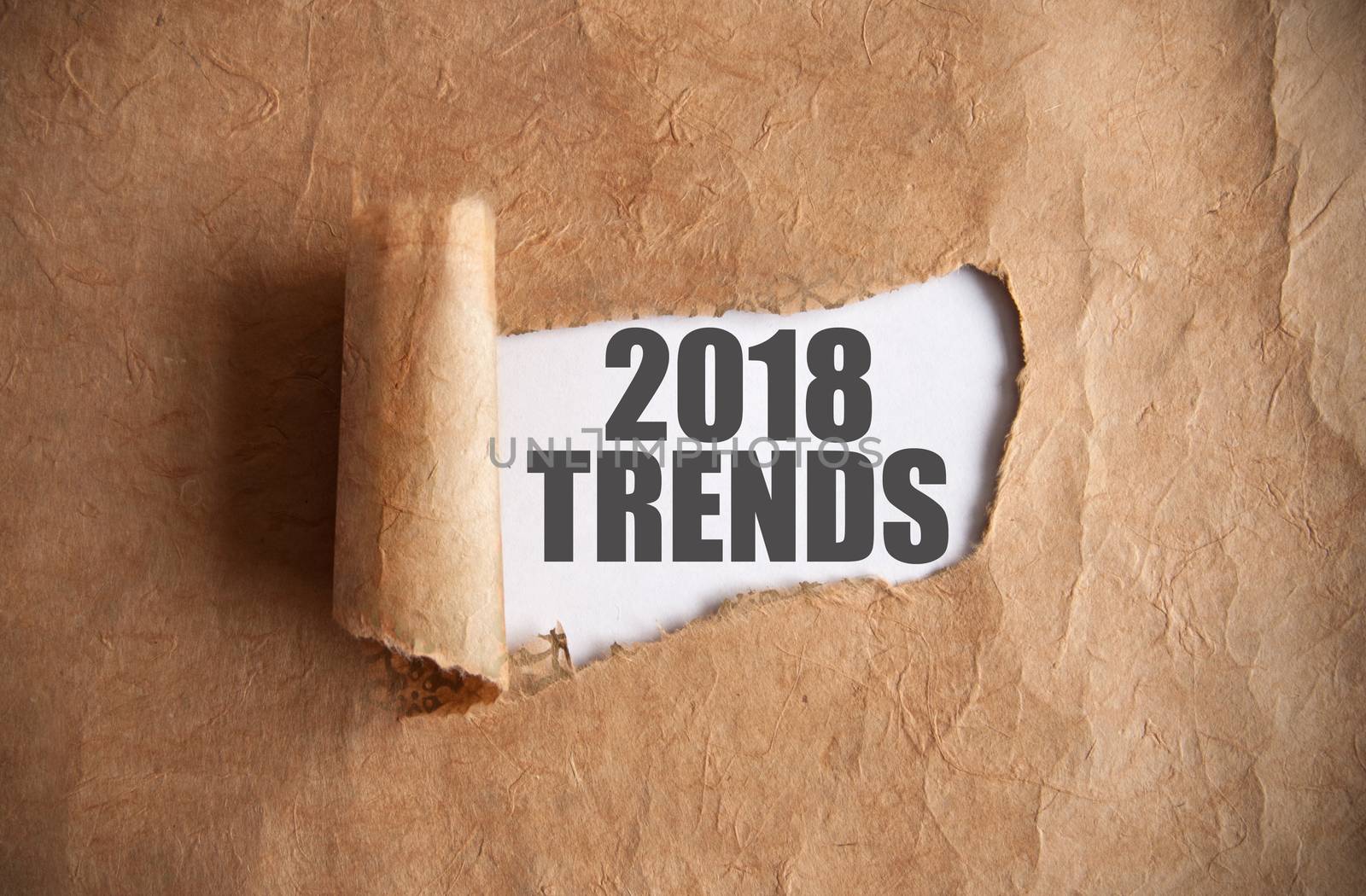 Torn piece of scroll uncovering 2018 trends underneath