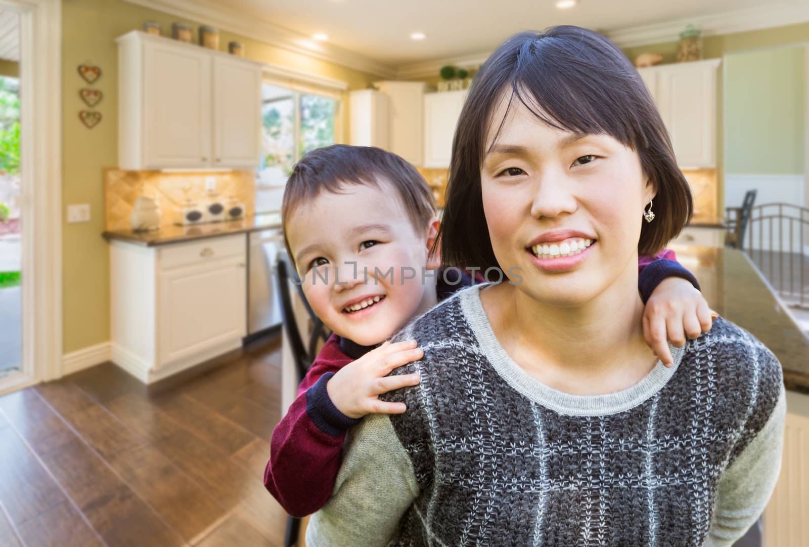 Chinese Mother and Mixed Race Child Inside Beautiful Kitchen. by Feverpitched